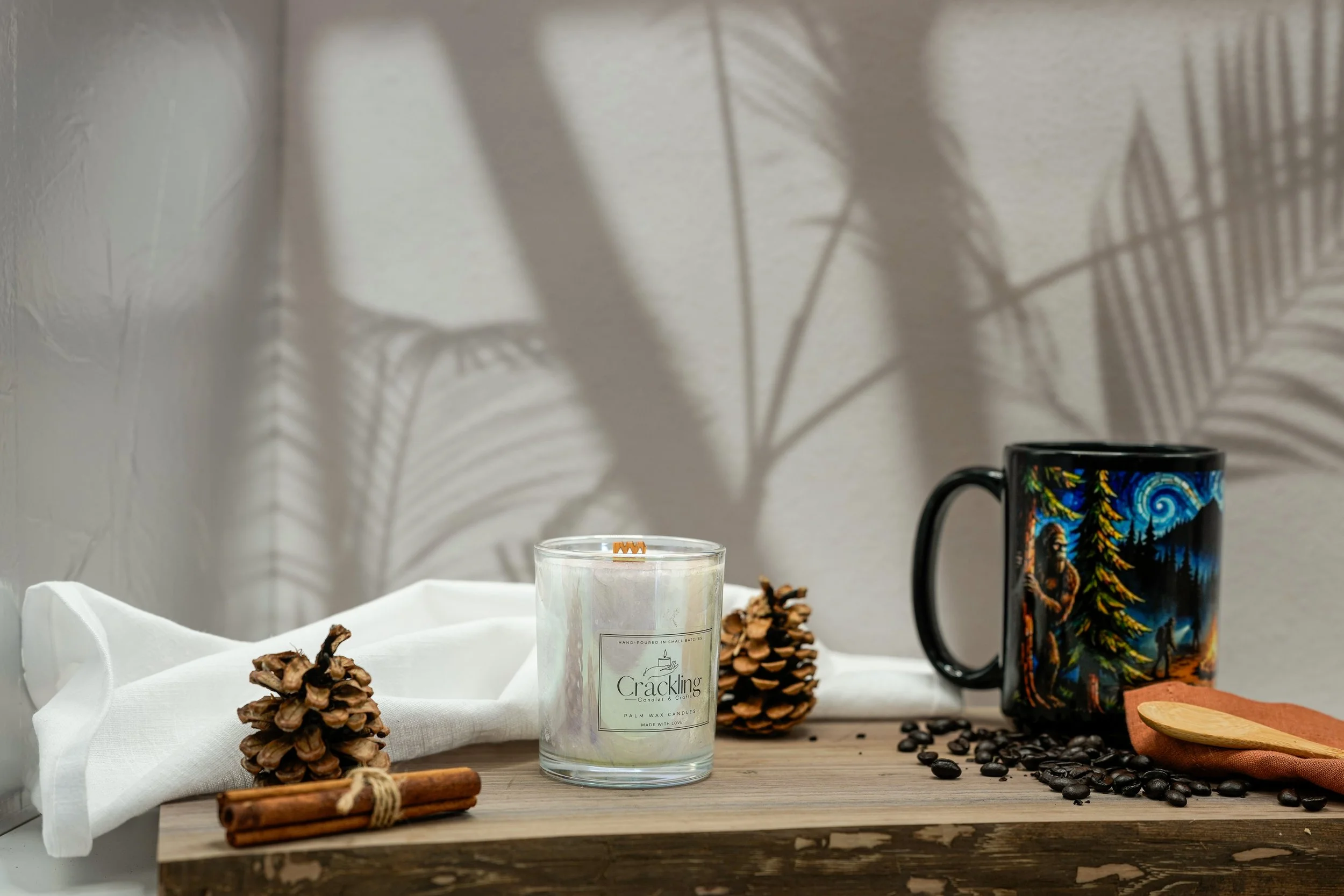 Hand-poured 6 oz Coffee candle on a wooden board with a black illustrated mug and coffee beans
