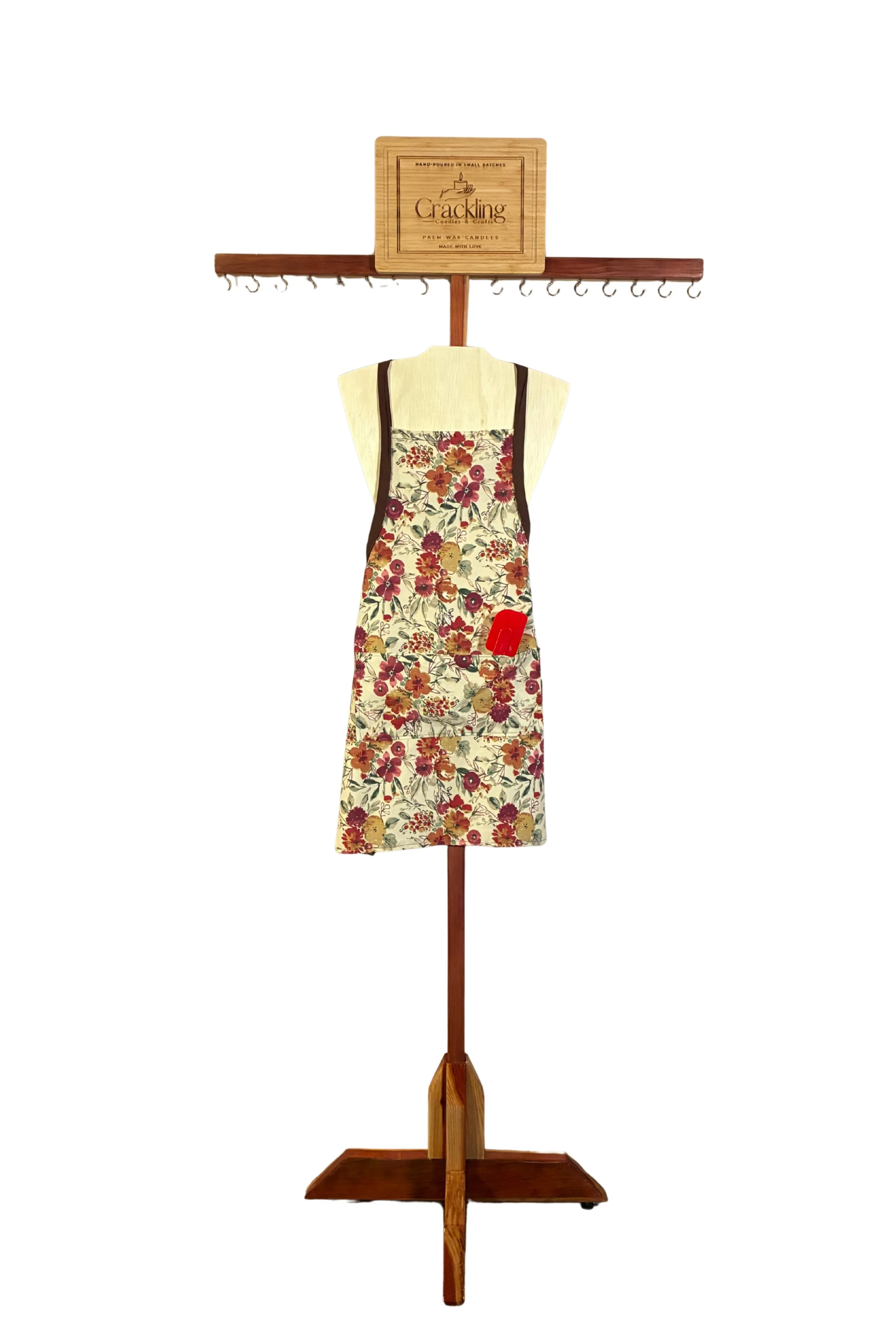 Handmade fall floral apron with brown straps and a front pocket, displayed on a wooden torso.