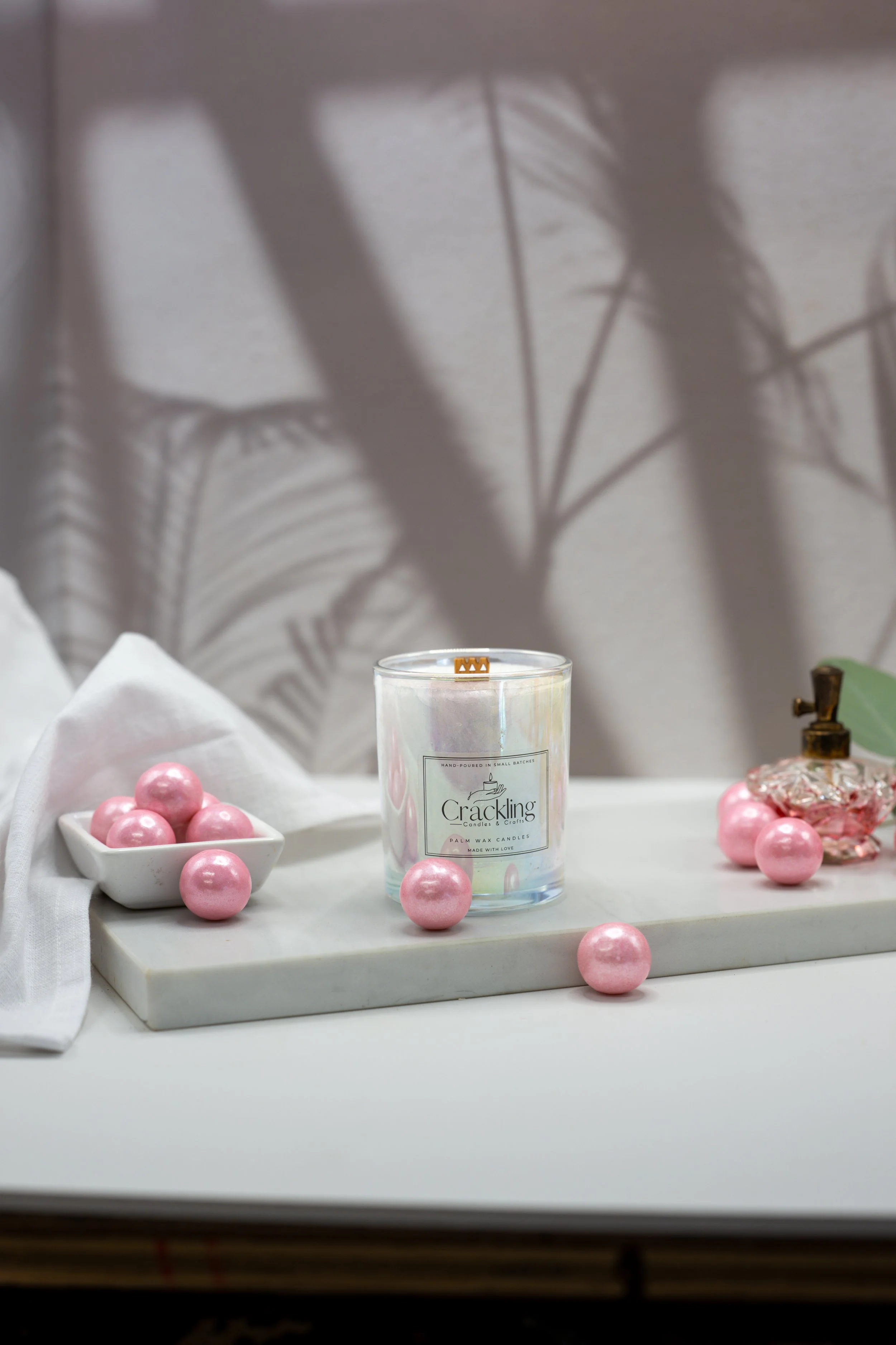 Hand-poured Bubble Gum candle displayed with glossy pink gumballs and soft linen in a playful spa-inspired setting.