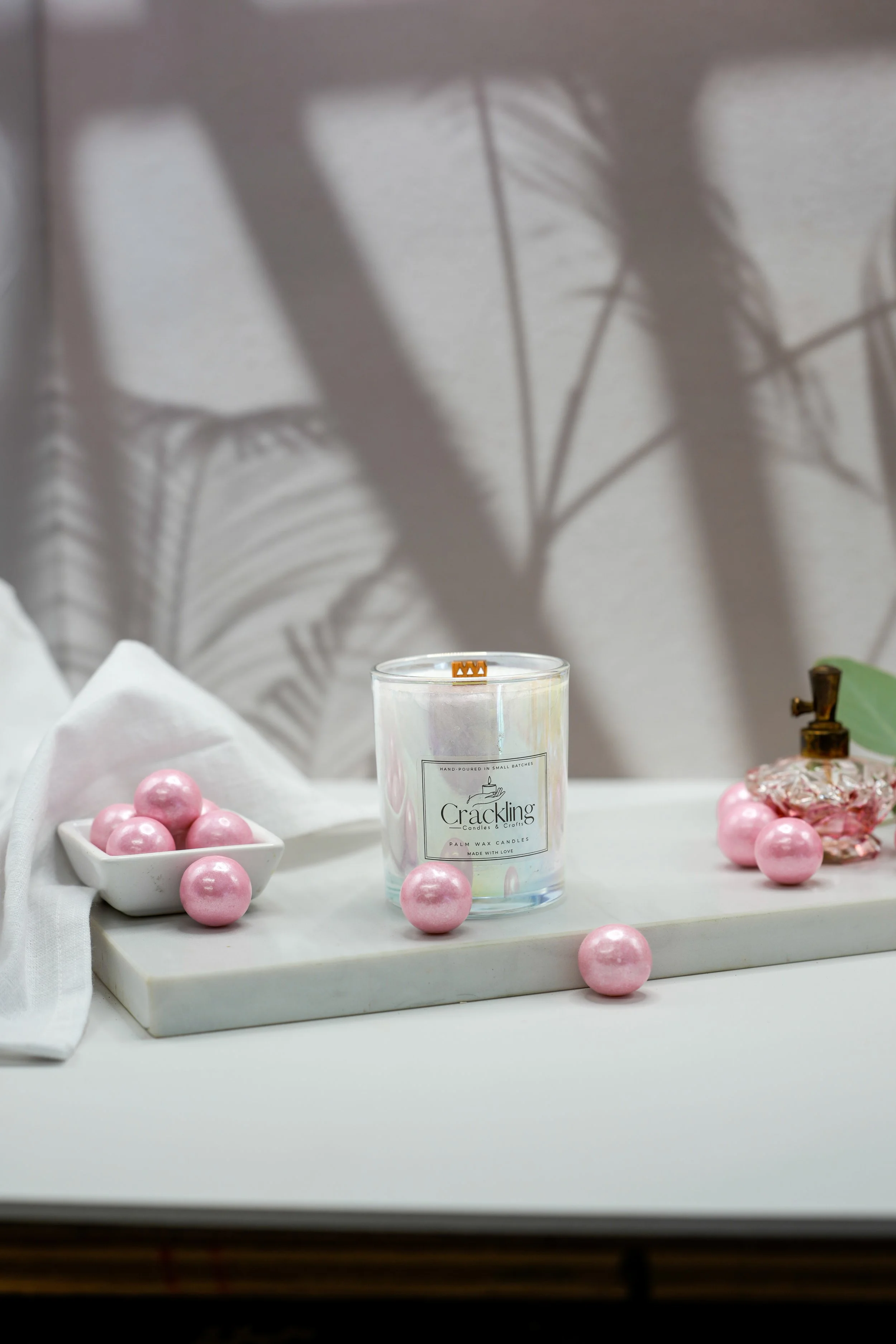 6 oz Bubble Gum candle with a wooden wick, styled with pink gumballs, white linen, and a soft neutral backdrop.