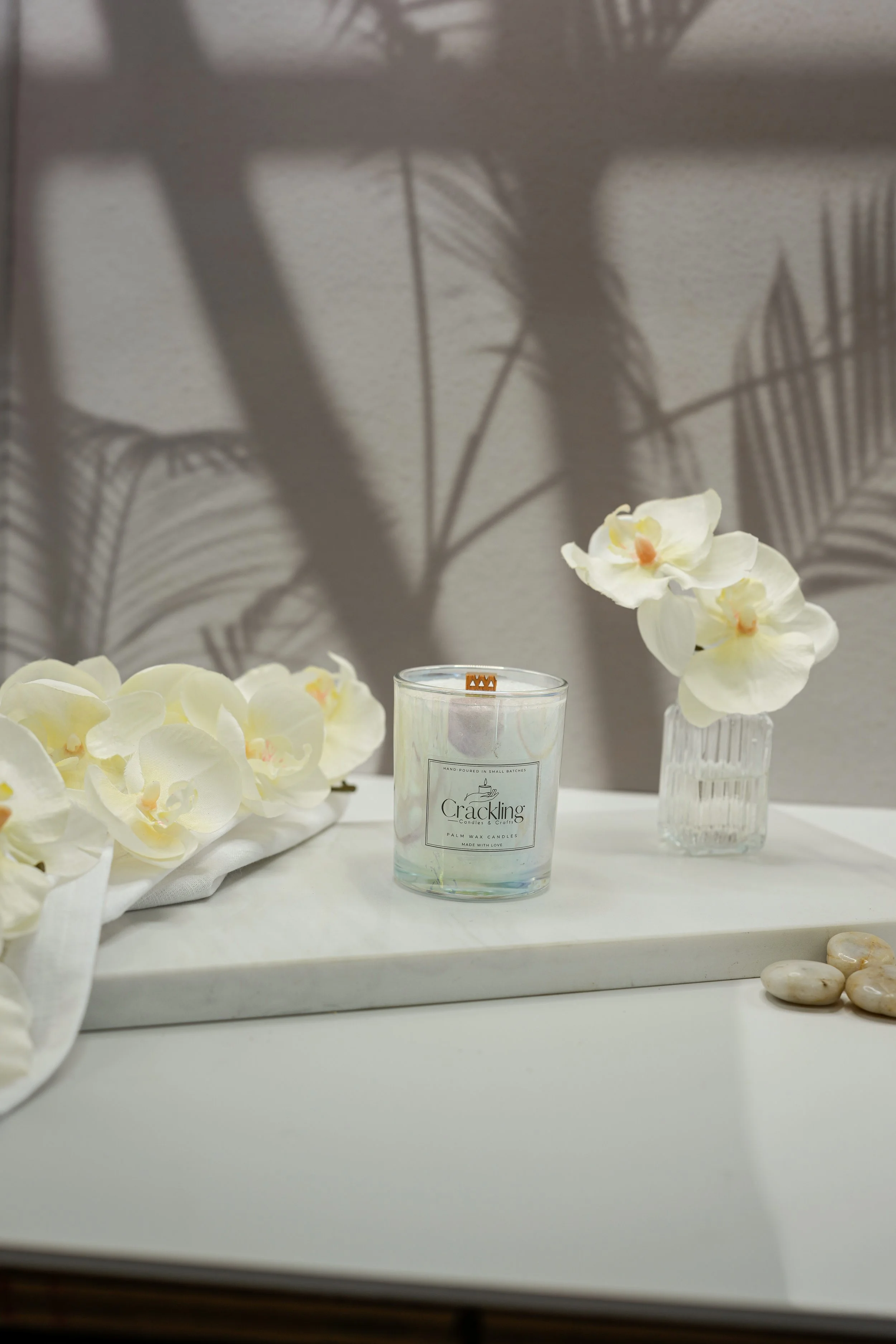 Front view of the Gardenia Bouquet candle styled with white flowers and a soft neutral backdrop.