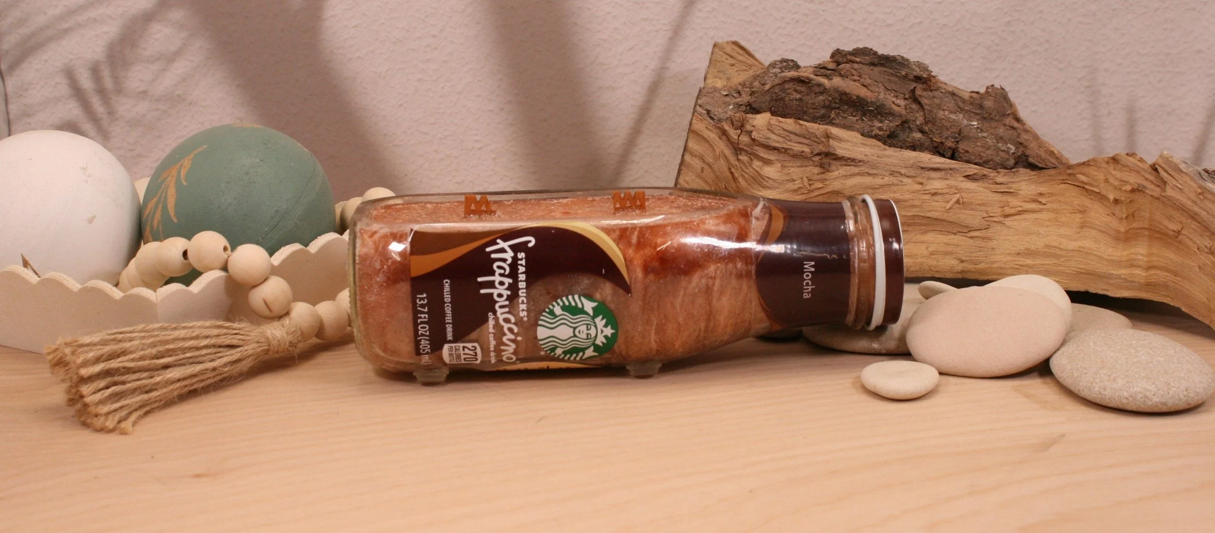 Our Upcycled Starbucks Frappuccino candle is cut on the side, has high temp non-skid pads for safety. Adds a unique addition to any space