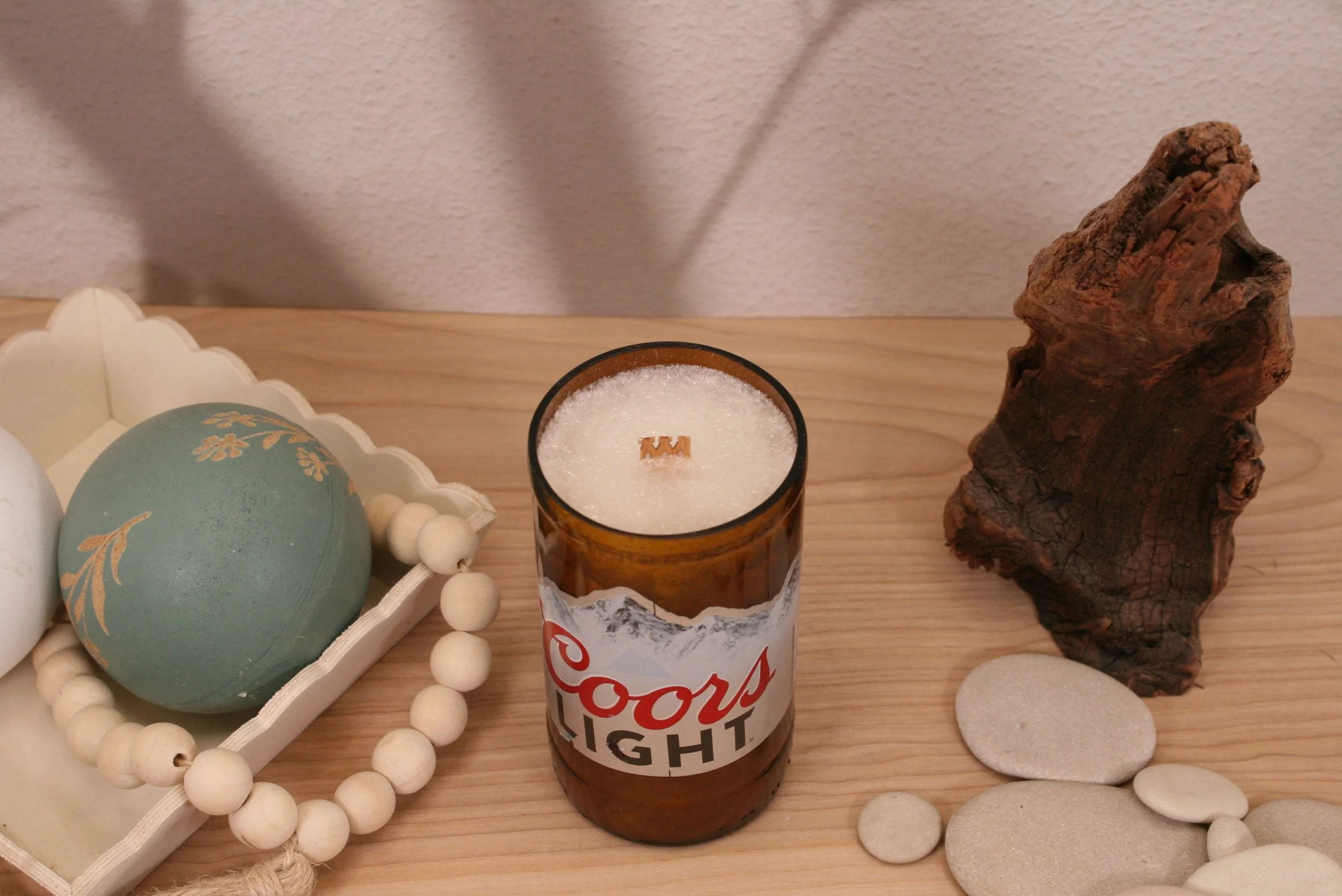 Our Coors Light Upcycled Beer Bottle Candle is a unique, eco-friendly piece that makes a perfect gift or a special treat for yourself.  Made to order with sustainable Palm Tree wax