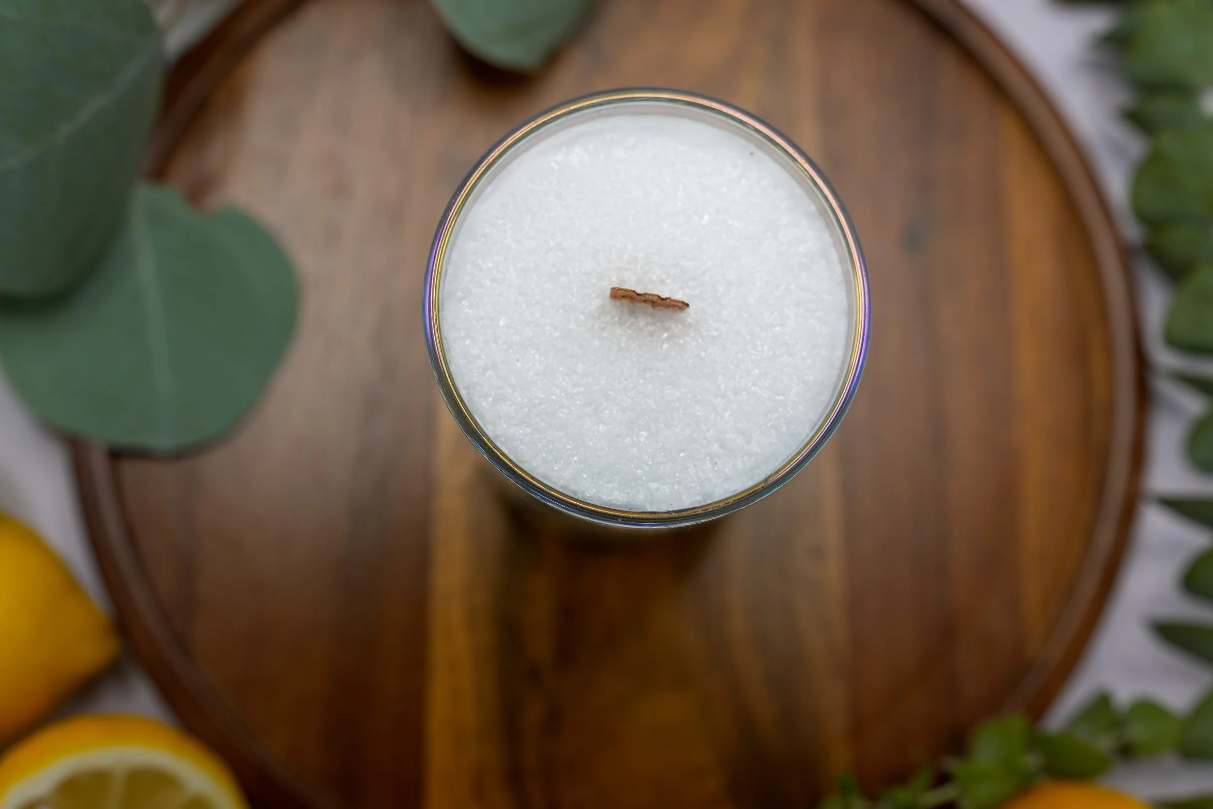 Top view of Lemon palm wax candle showing its crystalline wax surface and centered wooden wick.
