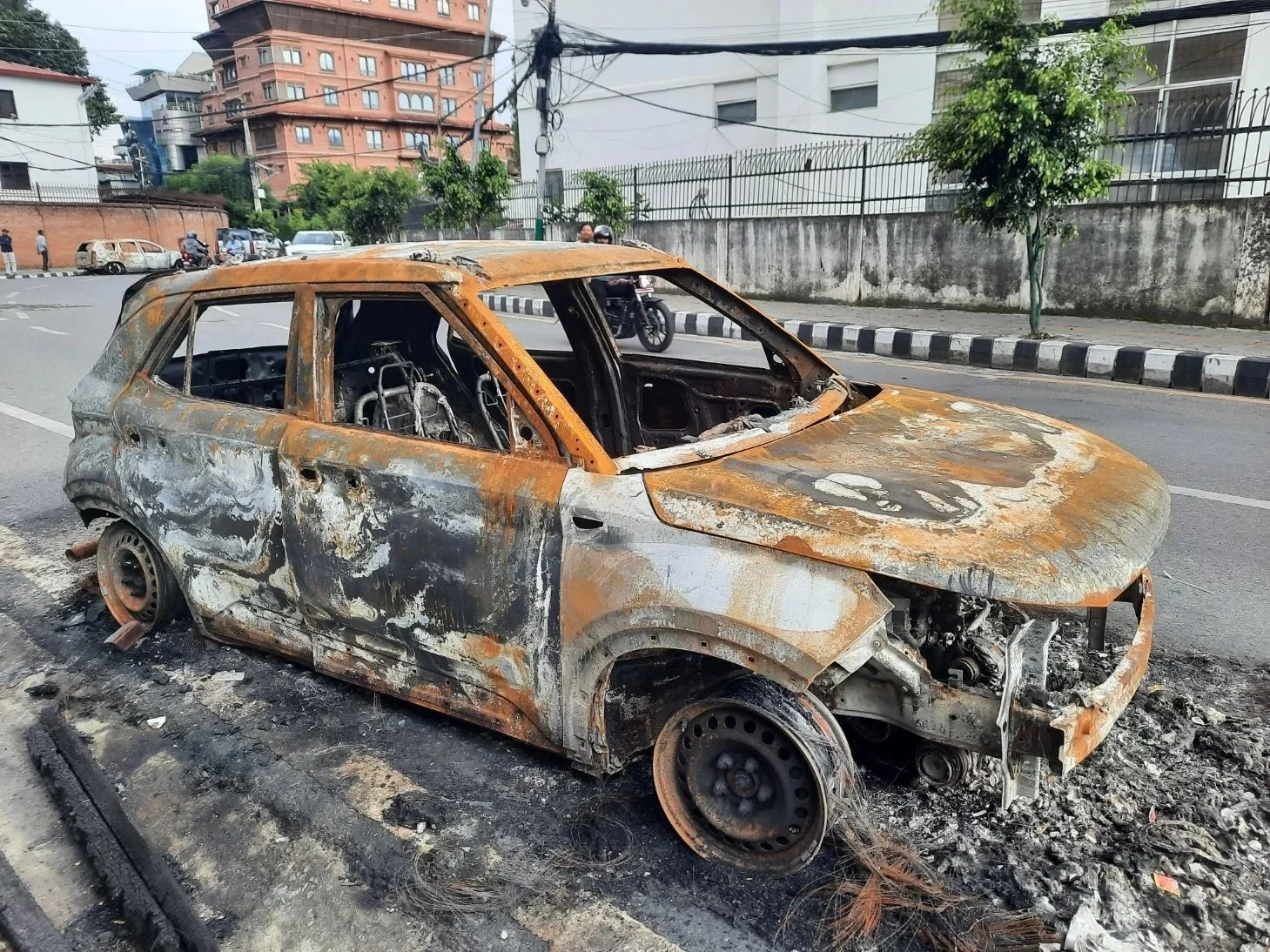 A burnt out car left on the road