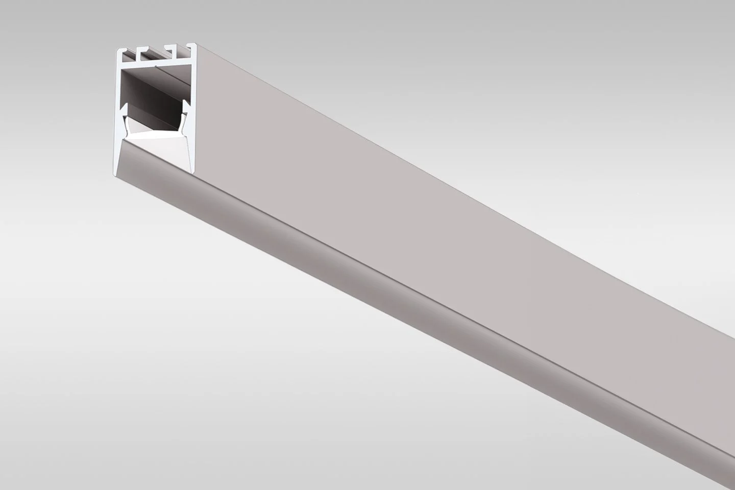 Close-up of a white aluminum extrusion with a hollow rectangular cross-section and a slot on one side, viewed from below at an angle.