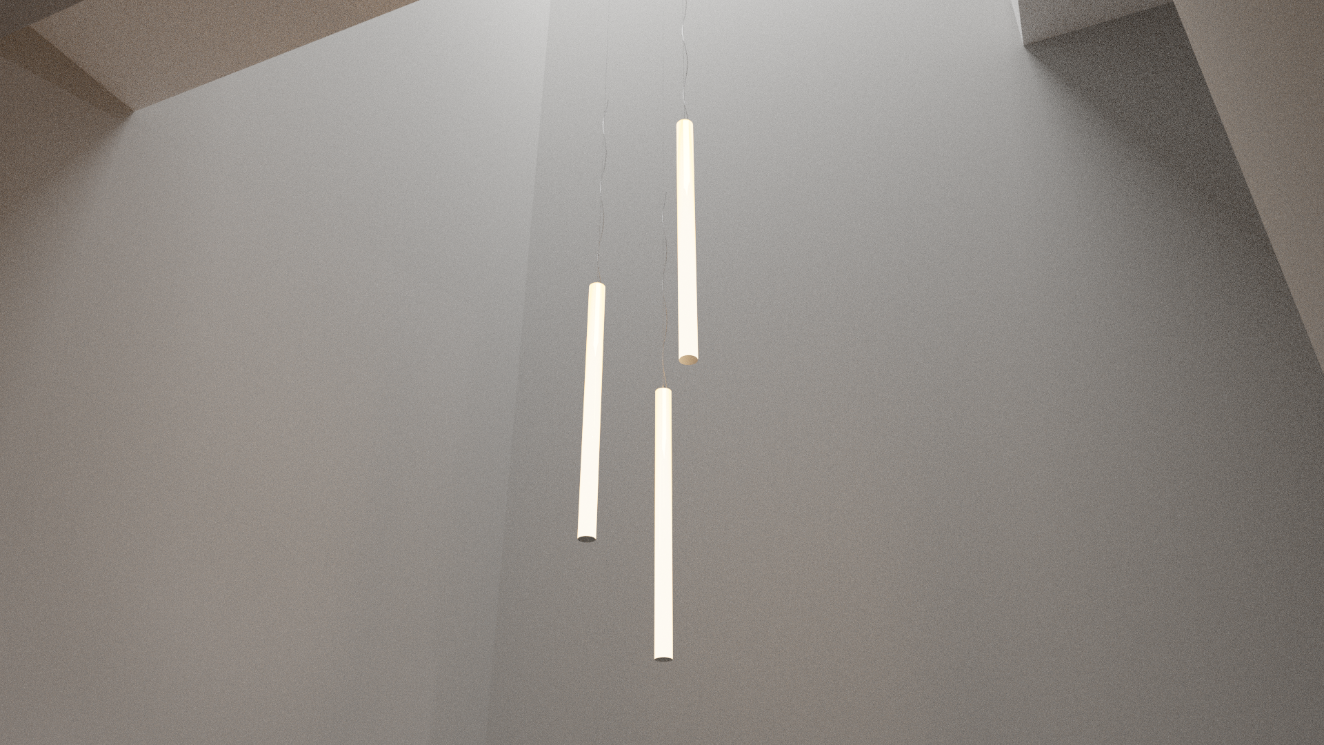 Modern minimalist pendant light fixtures hanging from the ceiling in a neutral-colored room.