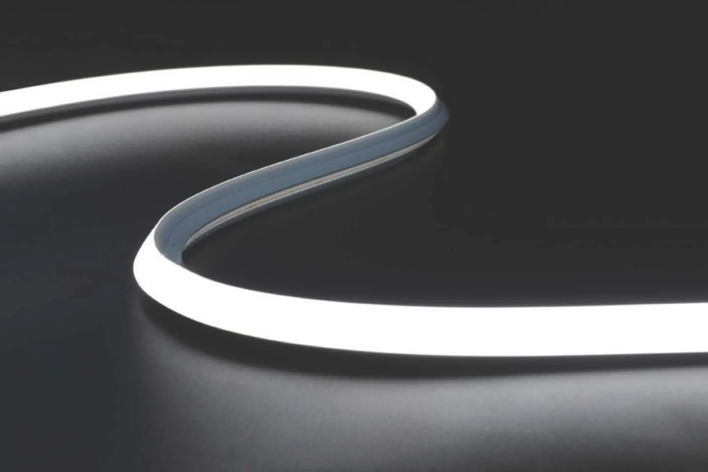 Close-up of a sleek, modern device with a glowing white circular ring against a dark background.