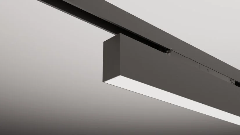Close-up of a modern, minimalist pendant light fixture mounted on a ceiling.