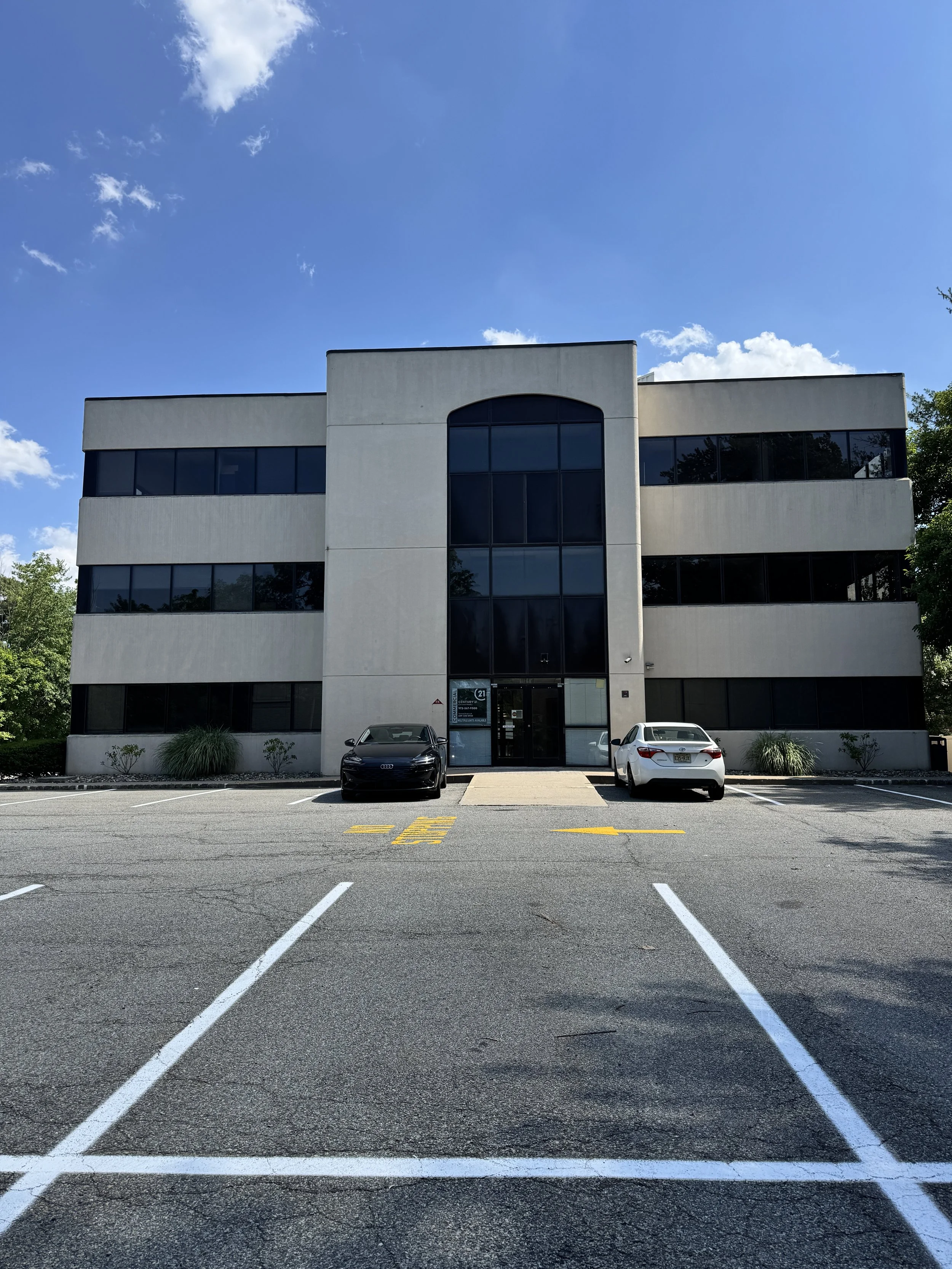 Exterior of the Bridging Bonds therapy office building at 160 Littleton Rd in Parsippany, NJ, with on-site parking