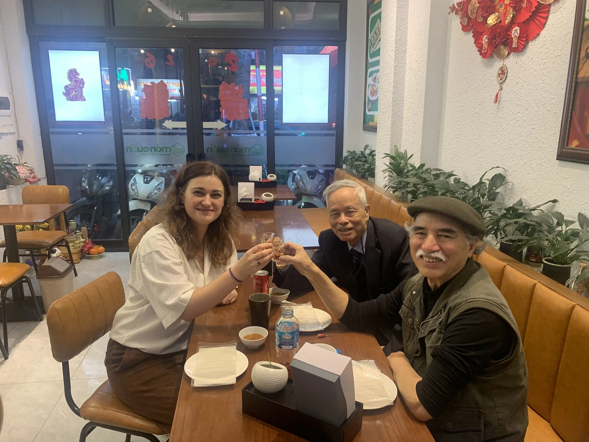Anna-Marie at dinner with Ngô Quang Nam and Vietnamese sculptor Nguyễn Phú Cường at dinner in a typical Vietnamese restaurant after a studio visit.