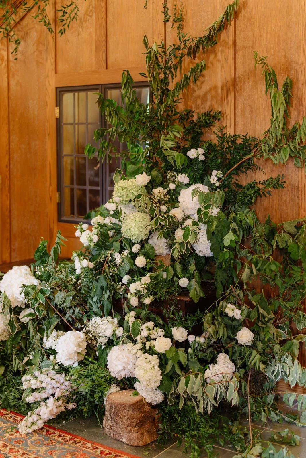 Large natural wedding flower installation in white and green