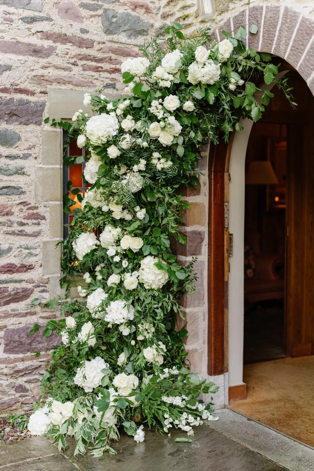 Wedding flower arch in front of front door Ard na sidh