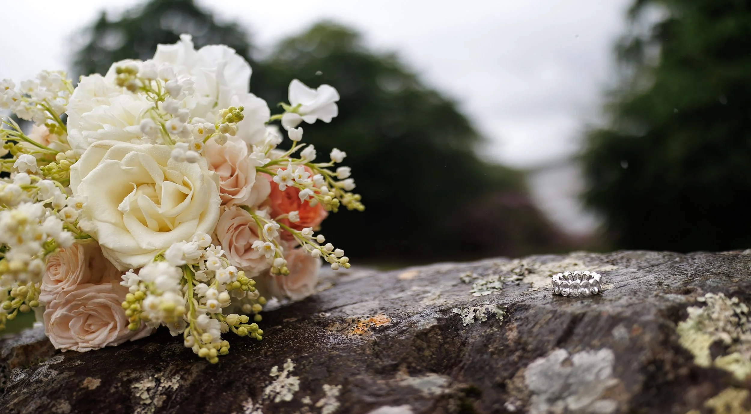 Close up bridal bouquet lilies of the valley and garden rose in pink and white