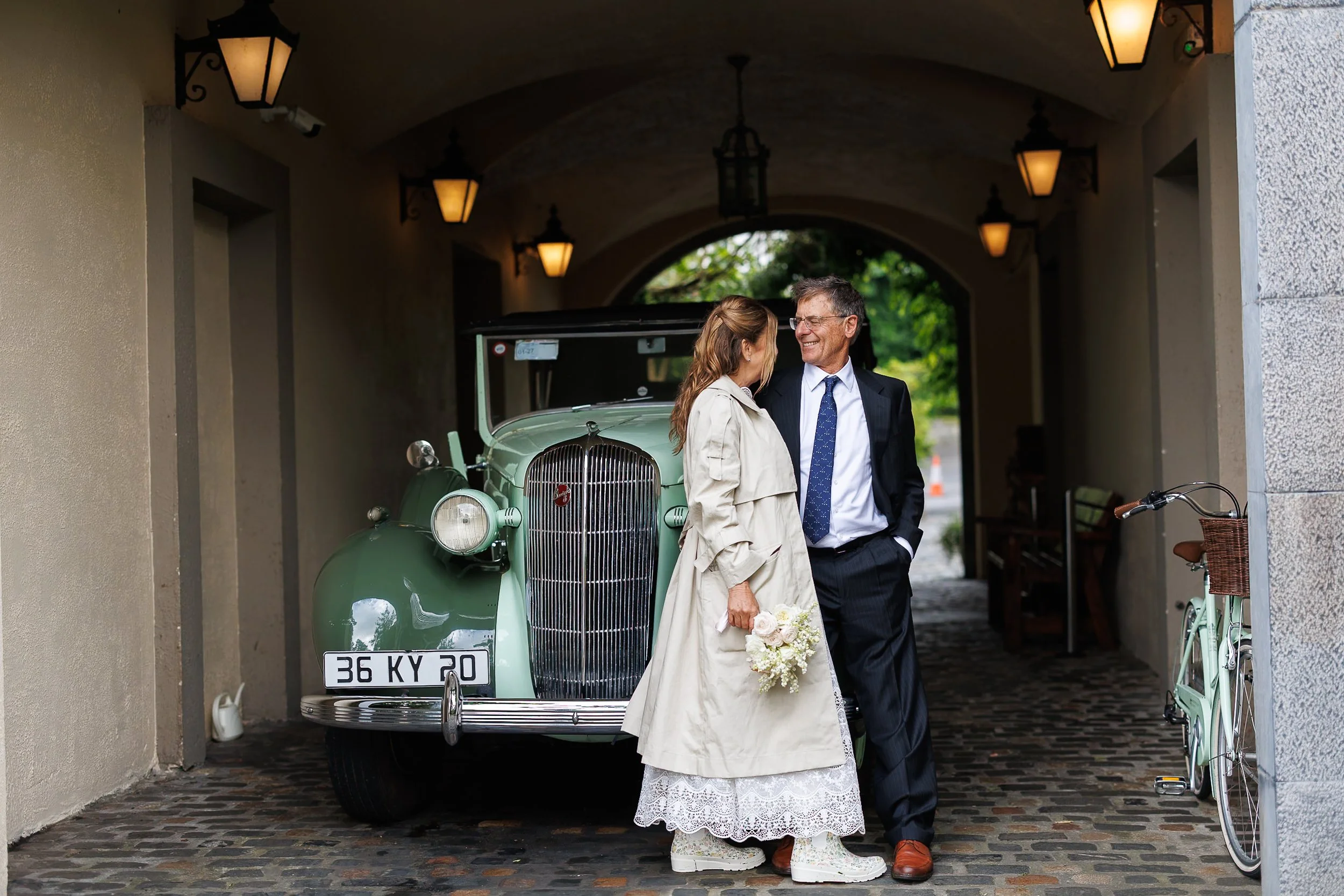 Wedding couple in front of old green car