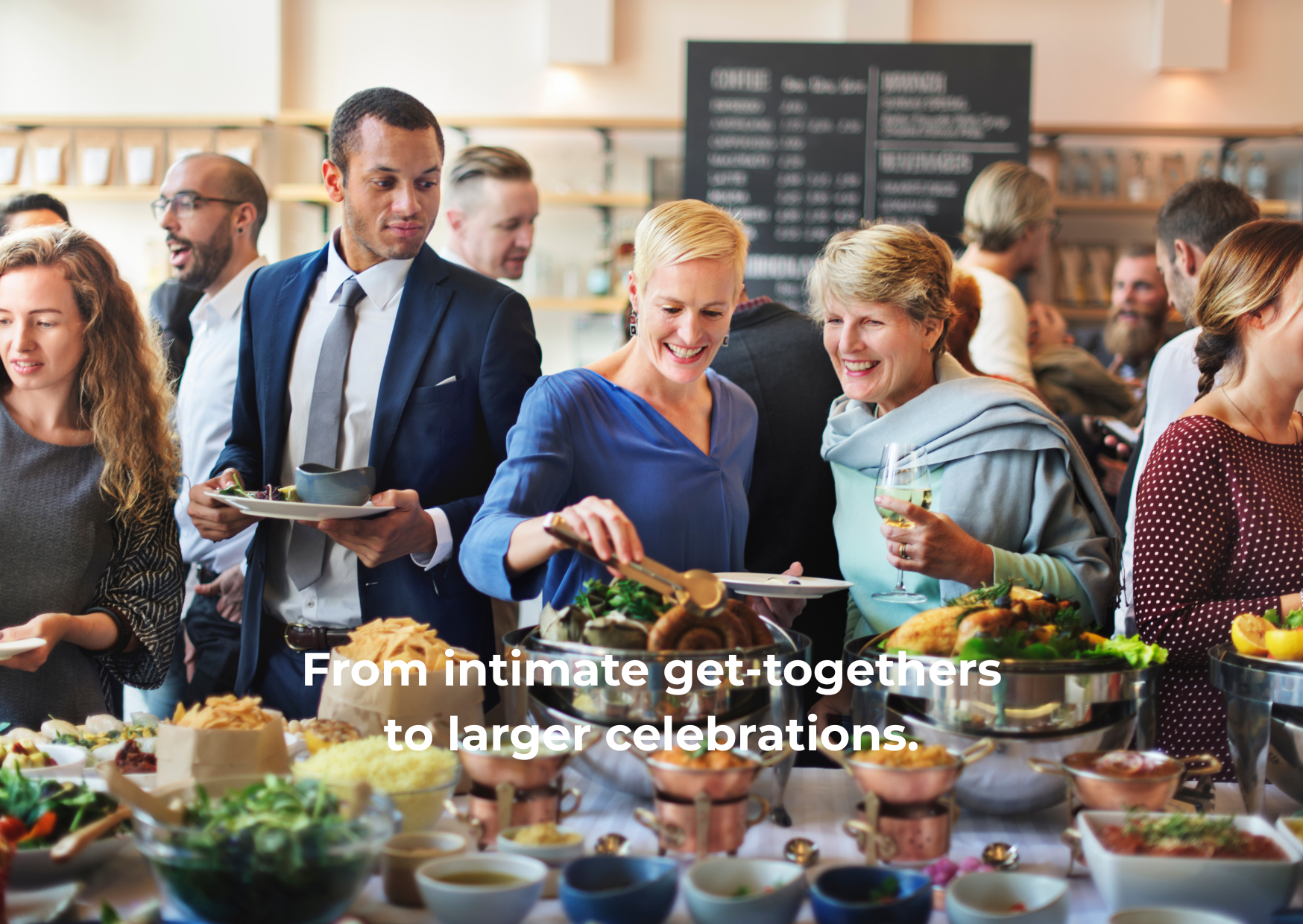 People at a buffet table enjoying food and drinks at a celebration.