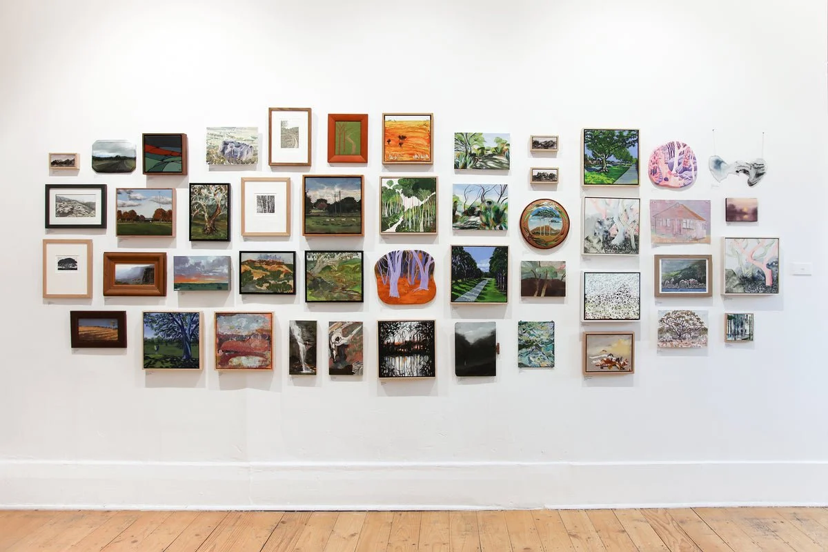 Small artworks displayed across a wall at Brunswick Street Gallery.