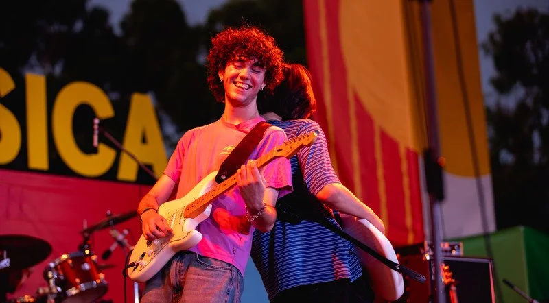 A musician playing bass guitar on stage at Powerhouse.