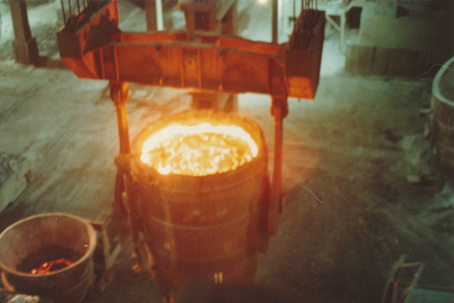 A ladle containing hot and orange melted steel