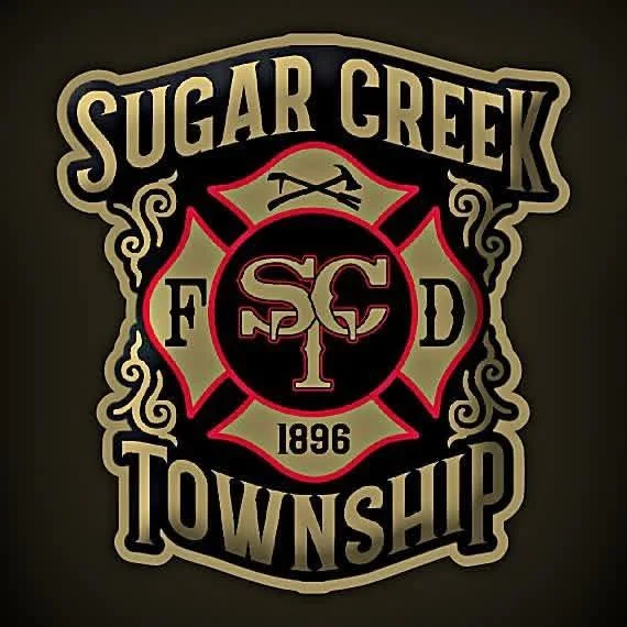 Logo of Sugar Creek Township with a central firefighter Maltese cross, the year 1896, and the words 'Sugar Creek Township'.