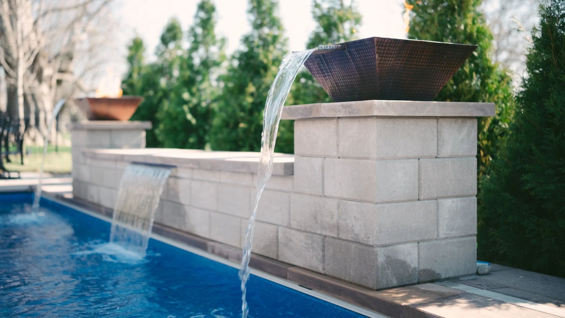 A fiberglass pool is a fantastic foundation for your backyard, but the real magic happens when you start adding those special touches around it. ✨ We always tell people to think about how they want to use the space. Adding a spill-over spa gives you 