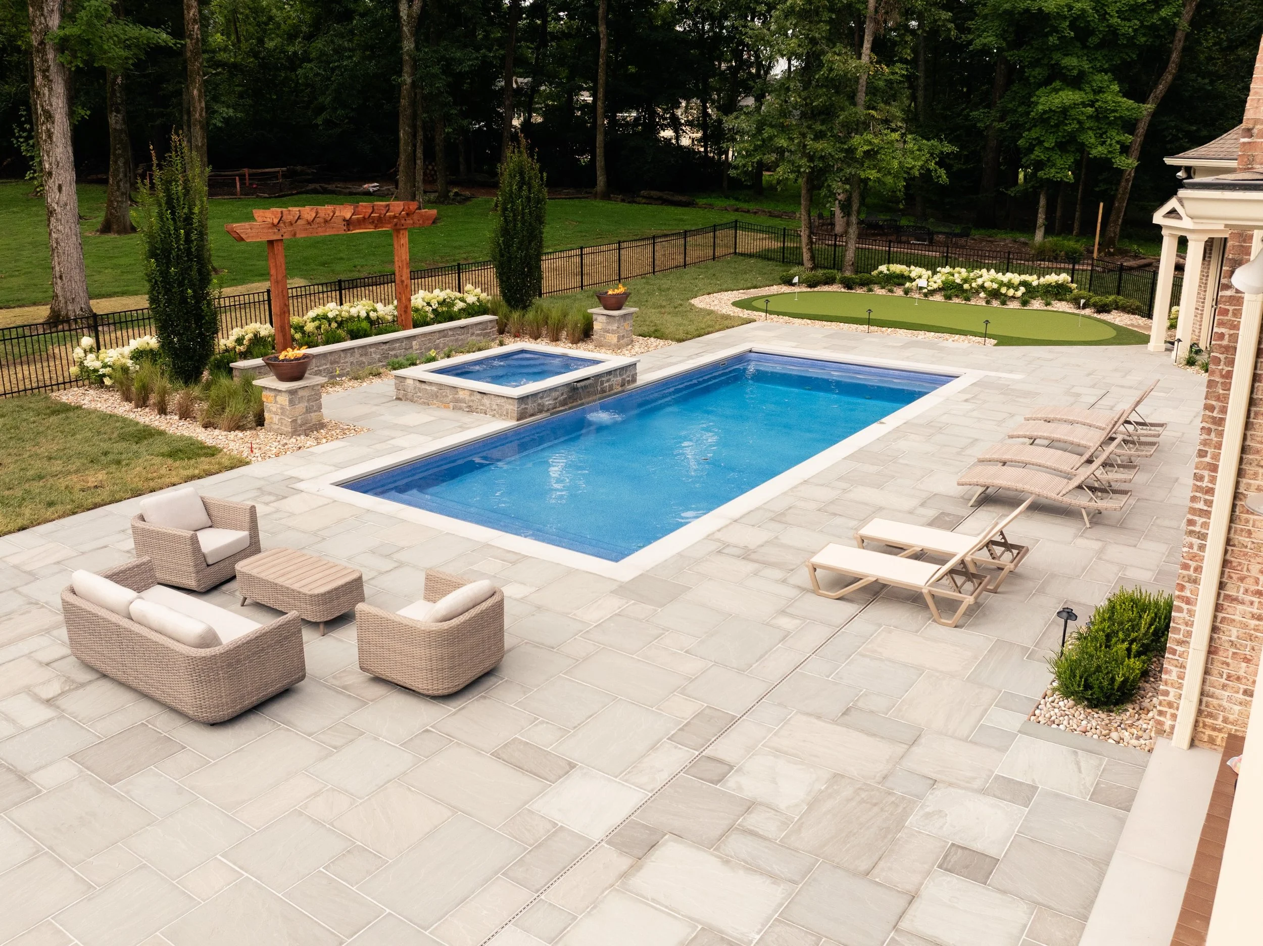 A turnkey backyard means everything you need for comfort and entertainment is built into one complete outdoor space. The custom pool steals the show, but every feature works together to create a backyard that's ready to enjoy from day one.