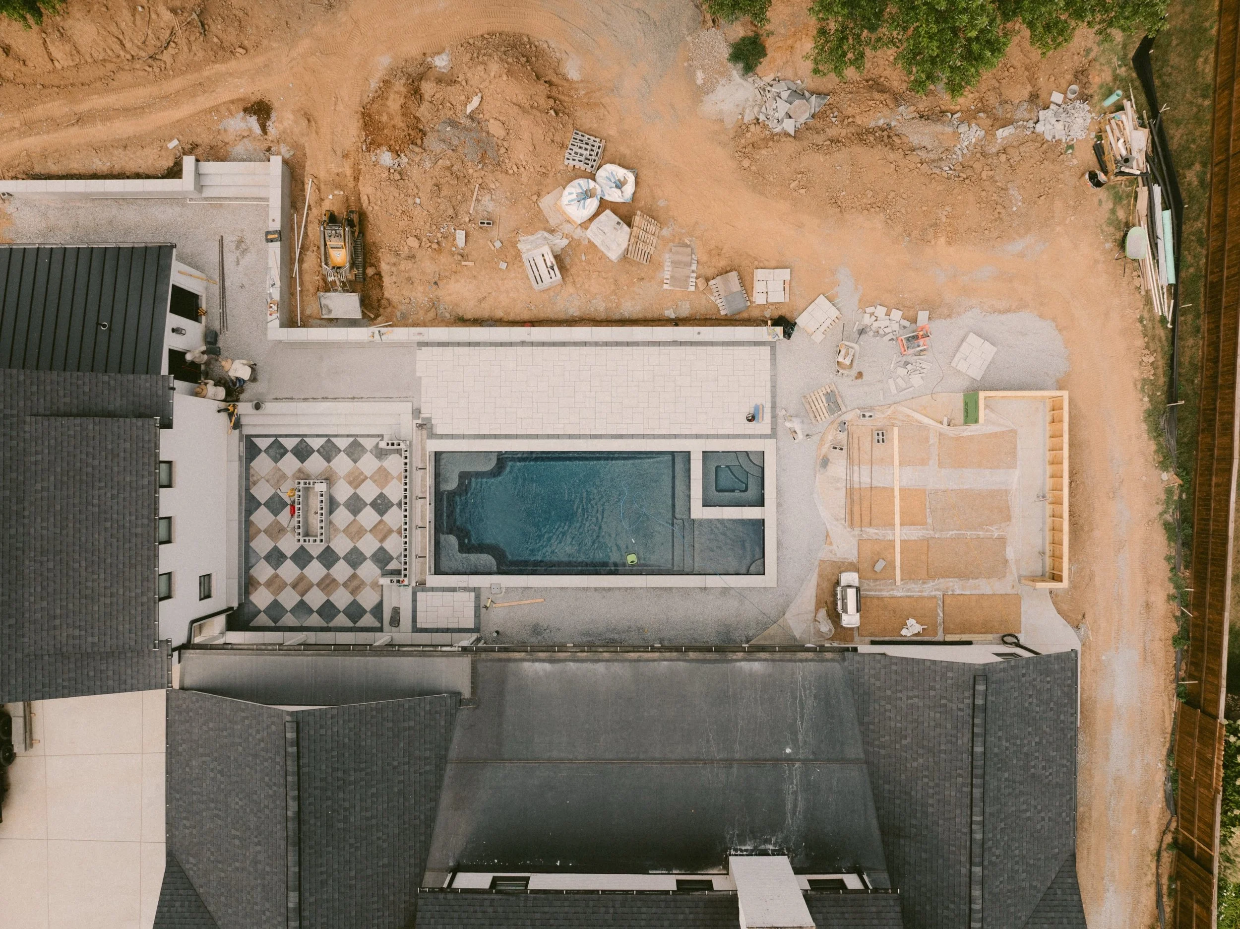 The pool may be full, but this job is far from finished.
Our crew is working through the next phase of this full-scale backyard build&mdash;laying pavers, finishing hardscapes, building out the surrounding spaces, and tying every piece of the propert