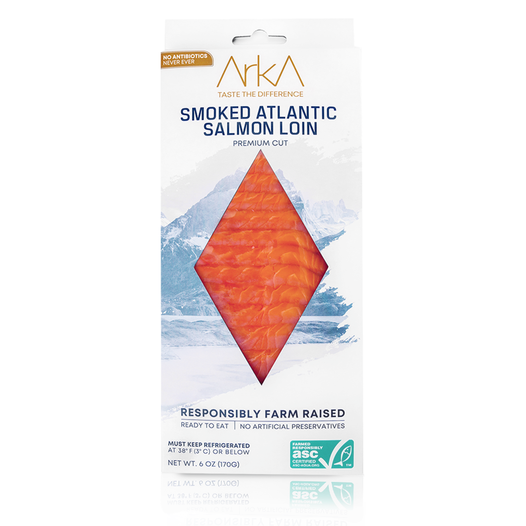 Package of Arka smoked Atlantic salmon loin with mountain background, labeled as responsibly farm raised, no antibiotics or artificial preservatives.