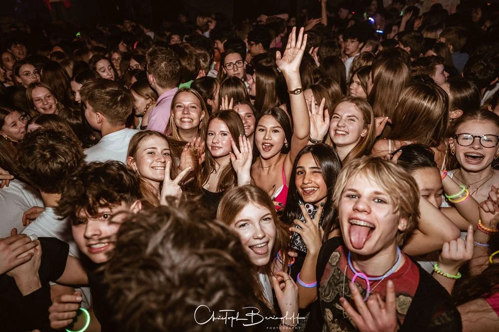 A group of young people at a party, laughing and having fun.