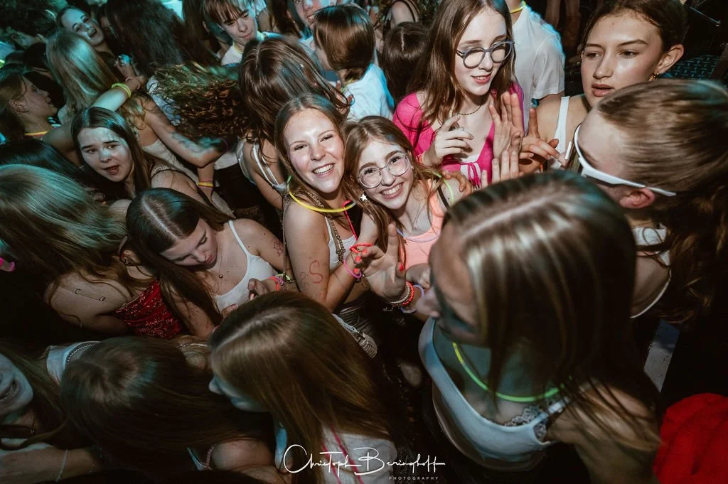 A group of young girls laughing and having fun at a party.