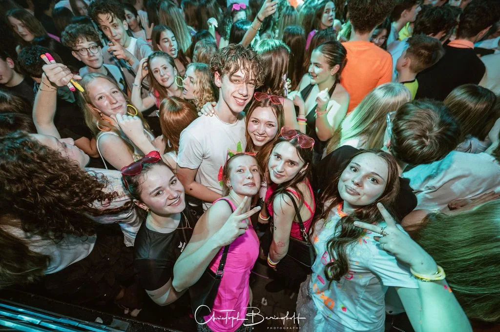 A group of young people at a party, laughing and having fun.