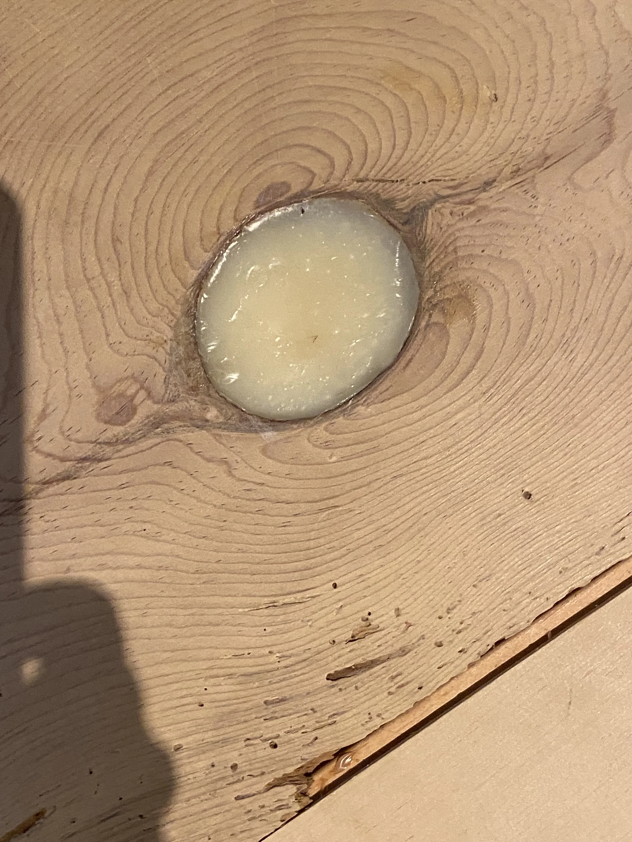 Knot in floor filled with epoxy (before)