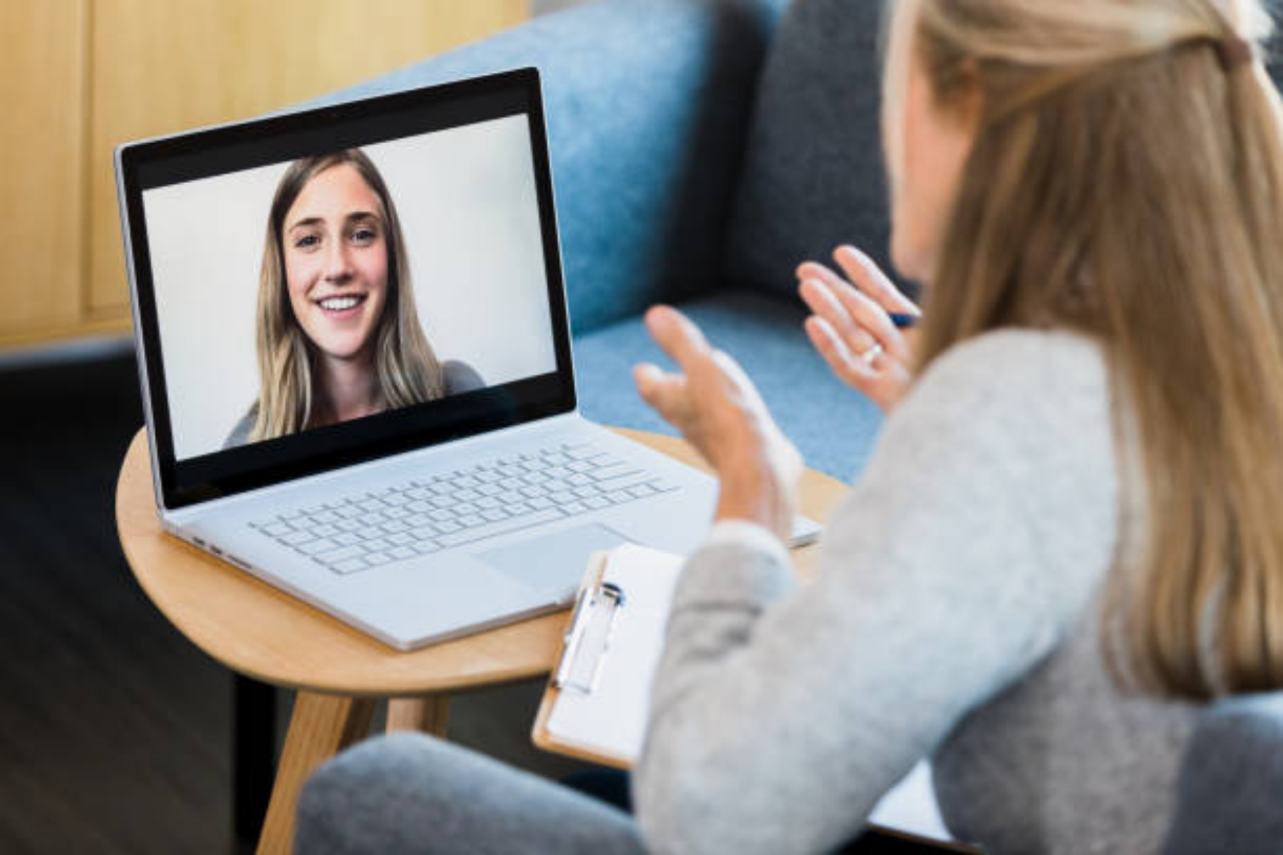 Therapist speaking to a client on a laptop during a virtual counseling session