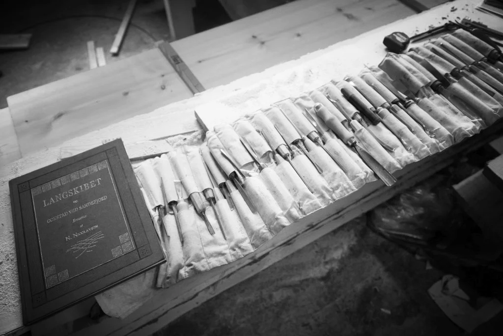 Tools used for woodcarving, some over a 100 years old, and the book about the patterns from the Gokstad ship.
