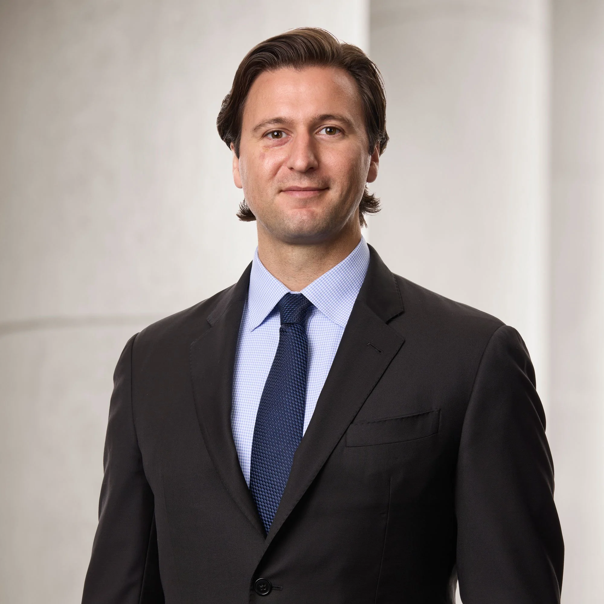 Portrait of Alexander Kalyniuk, senior associate at Baughman Kroup Bosse, on courthouse steps.