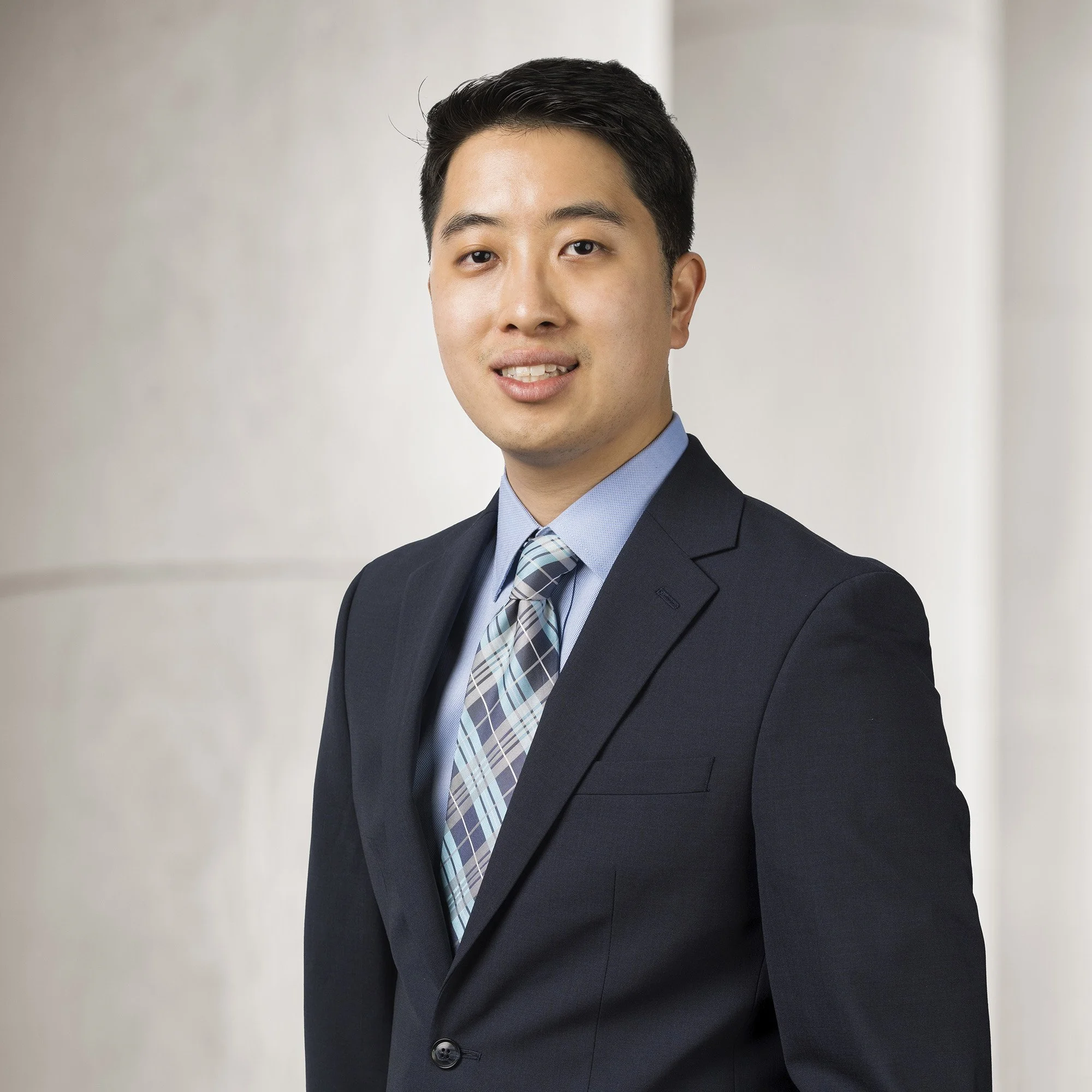 Portrait of Andrew Lee, Legal Analyst at Baughman Kroup Bosse, on courthouse steps. 