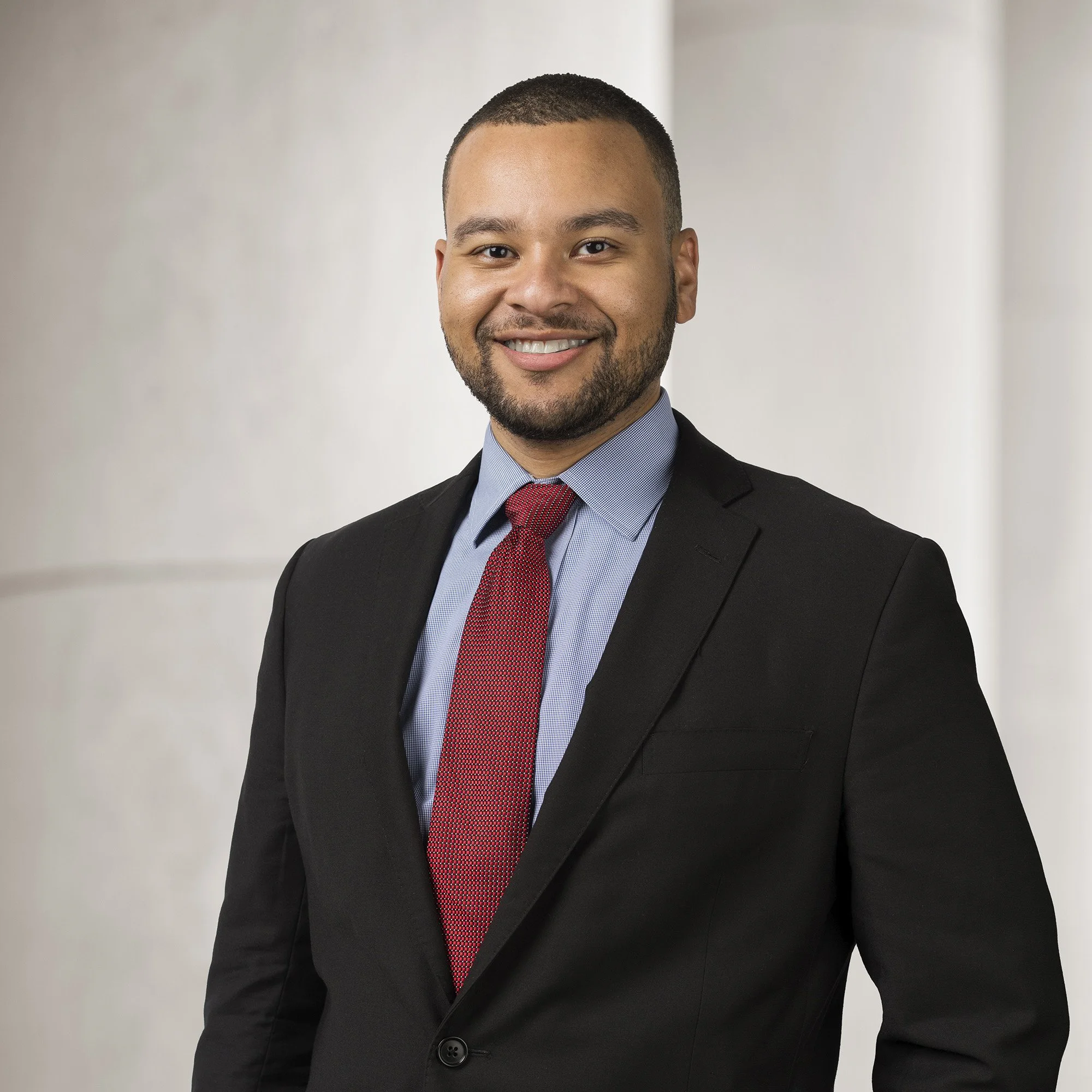 Portrait of Ernie Butner, an associate at Baughman Kroup Bosse, on courthouse steps. 