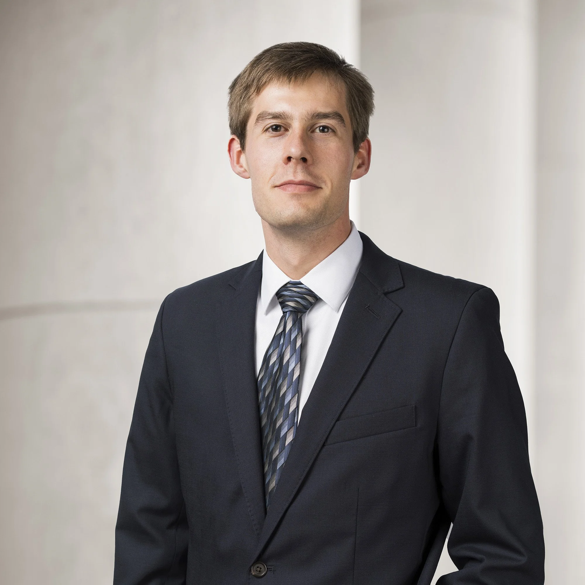 Portrait of Lincoln Trissell, Legal Analyst at Baughman Kroup Bosse, on courthouse steps. 