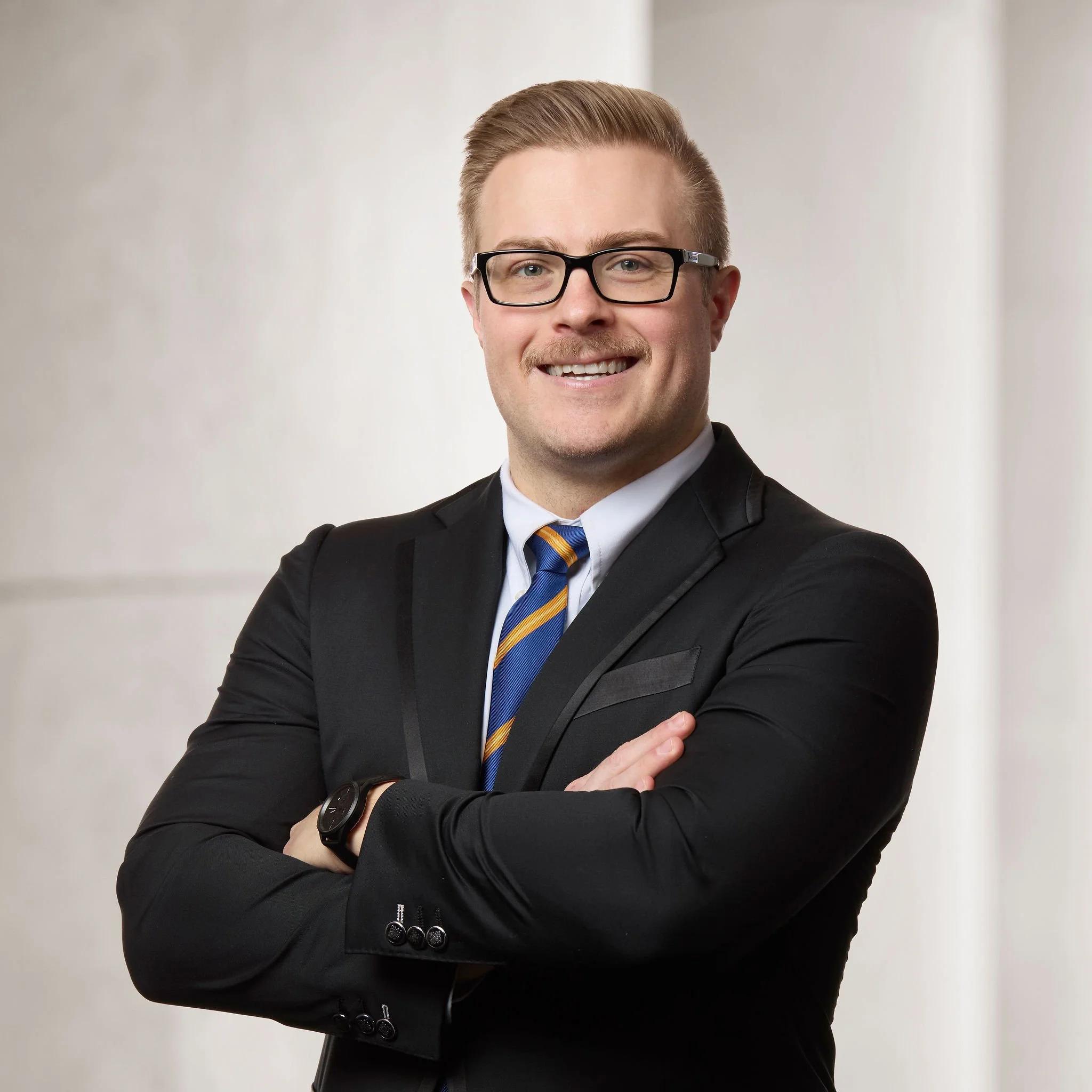 Portrait of Jordan W. Reece, an associate at Baughman Kroup Bosse, on courthouse steps.