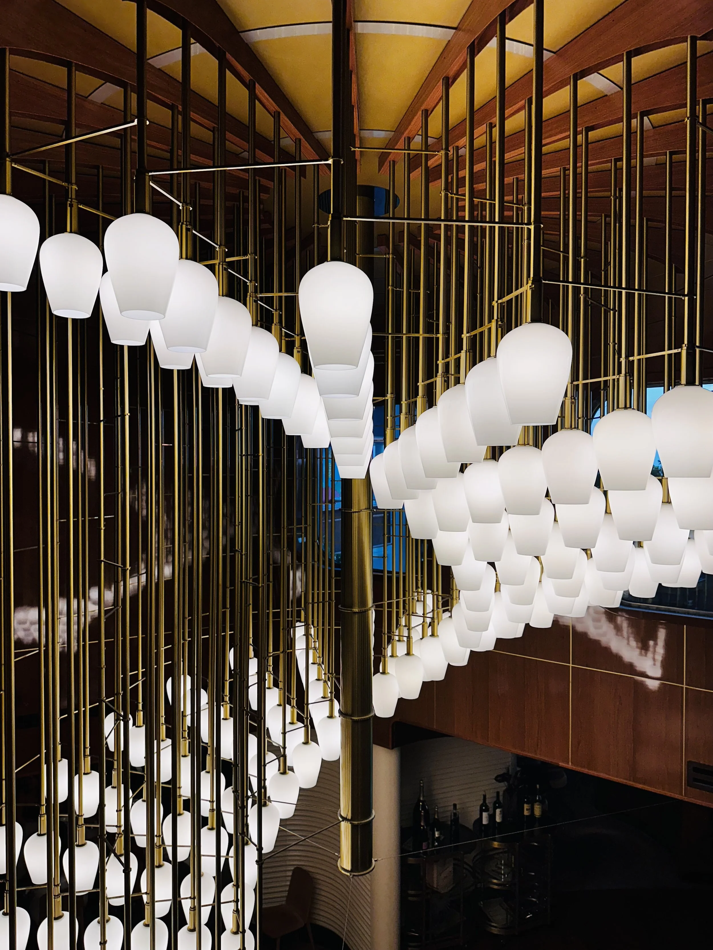 Luxury interior design on Virgin Voyages, showing the high-end staircase and lighting.