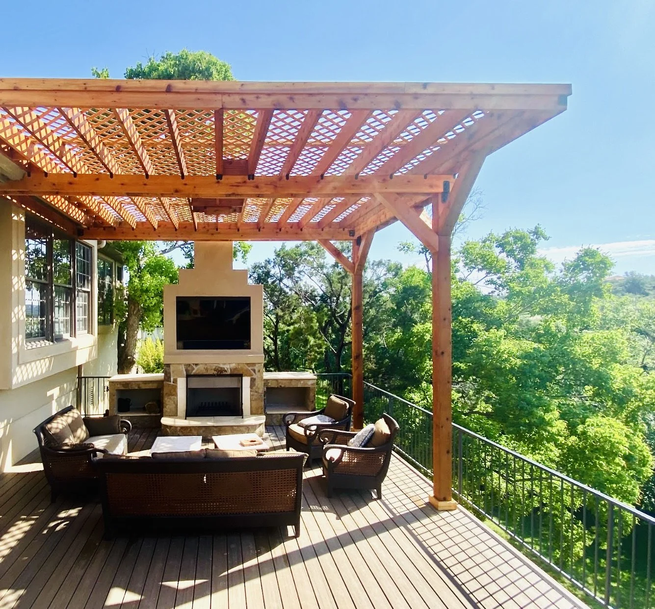 A beautifully crafted second-story deck featuring a custom cedar pergola and wood-burning fireplace, constructed of masonry and stone, for year-round outdoor enjoyment.