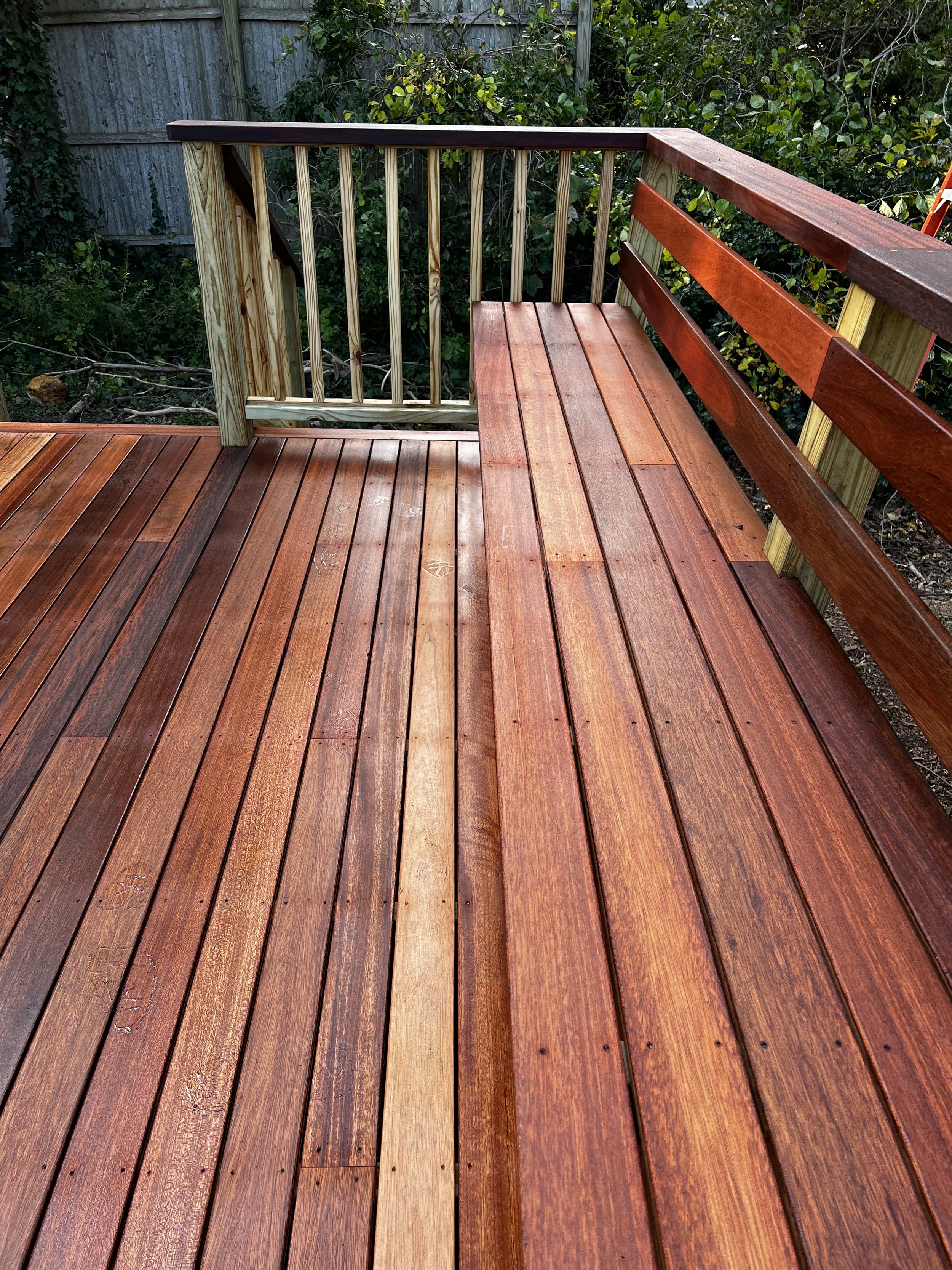 Featuring tropical mahogany decking and railing caps, matching white trim, two staircases and a built-in bench, this deck makes a great addition to this Martha’s Vineyard summer home.