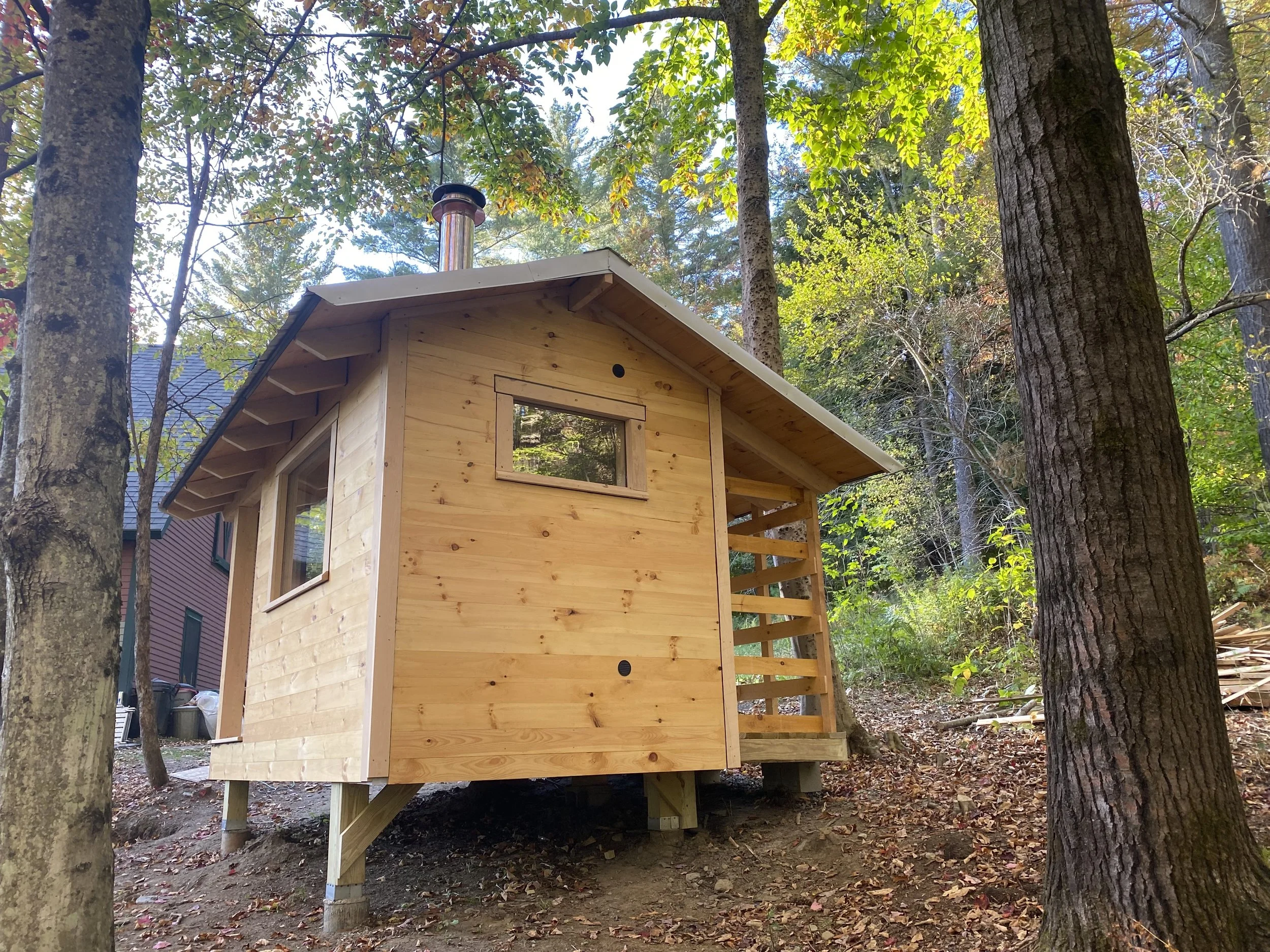 A peaceful sauna retreat with unobstructed views, natural materials, and a cozy cedar-lined interior.