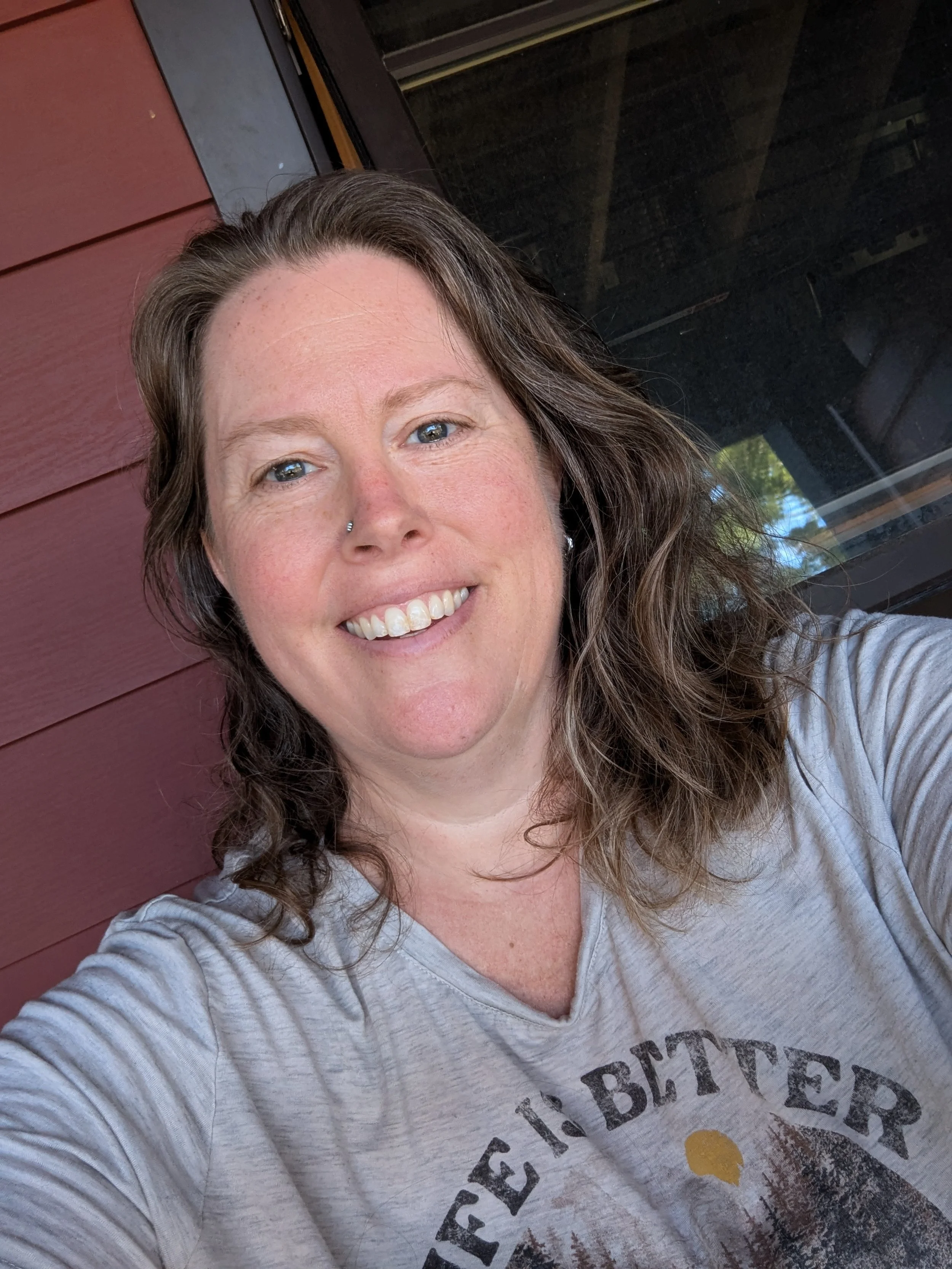 smiling woman, bright eyes, t-shirt says Life is Better