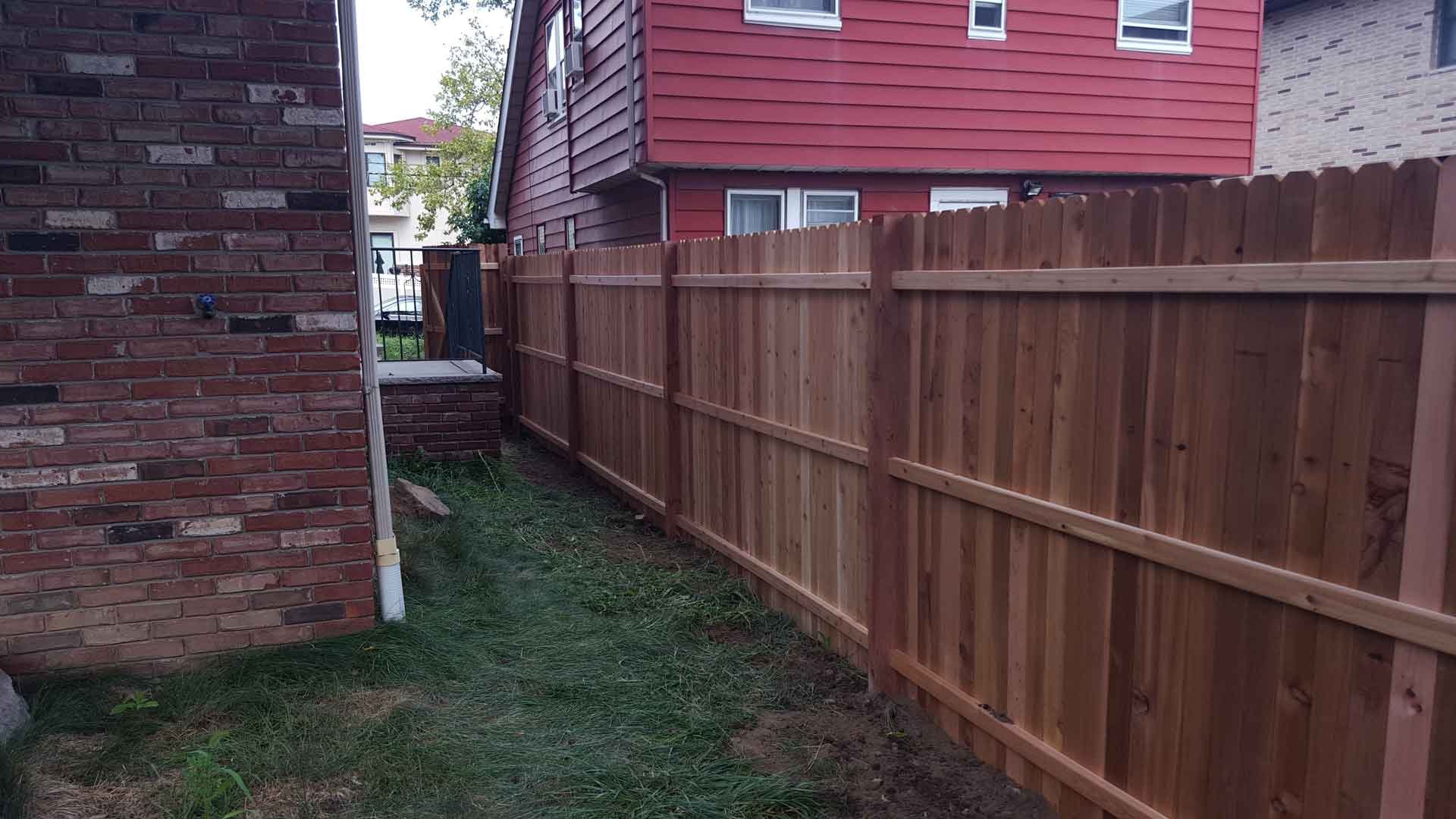 Timeless Property Boundary: Empire Fence creates enduring beauty with a wood fence that stands the test of time.