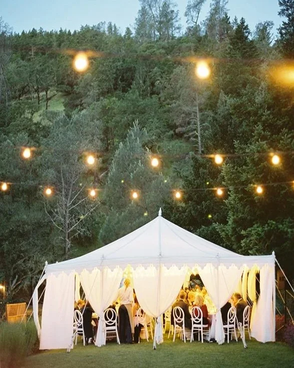 Napa Valley wedding guests sit under a moroccan style tent amidst the landscape of a 5 Star Napa Valley Resort