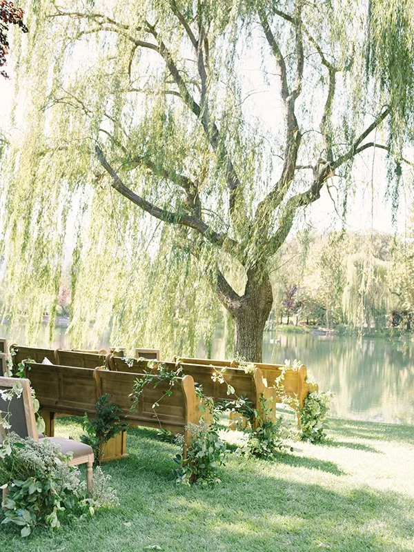 Wine Country wedding ceremony in Napa Valley with vine draped pews amidst vineyard