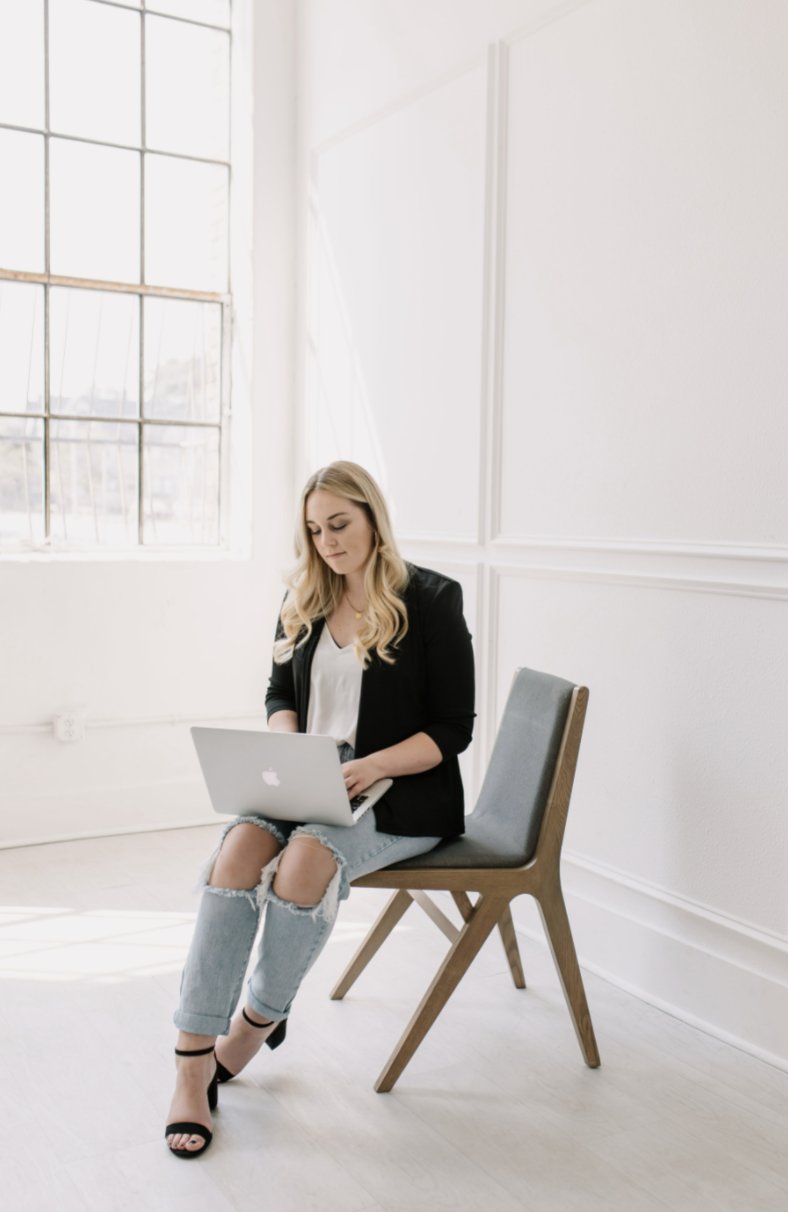 Taylor Garcia - Real Estate Guide of 6th Ave Homes - working on laptop