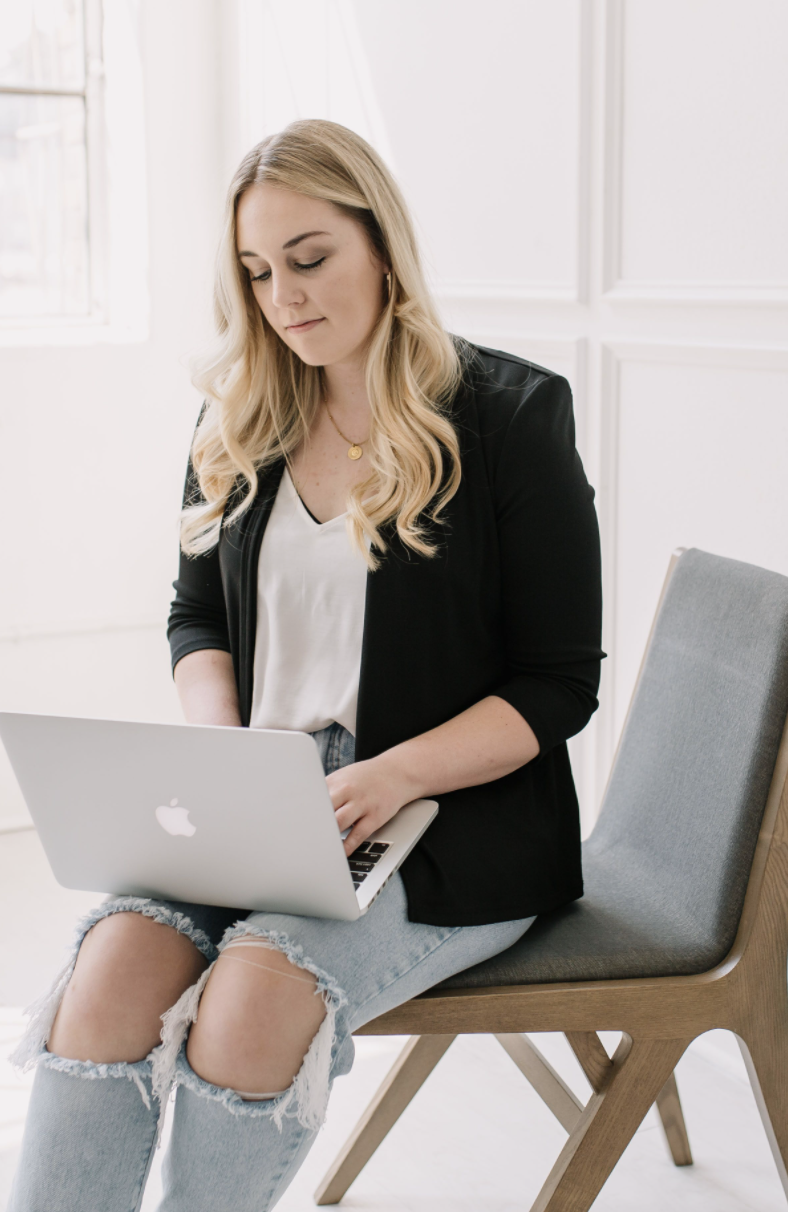 Taylor Garcia - sitting on chair working, working on laptop