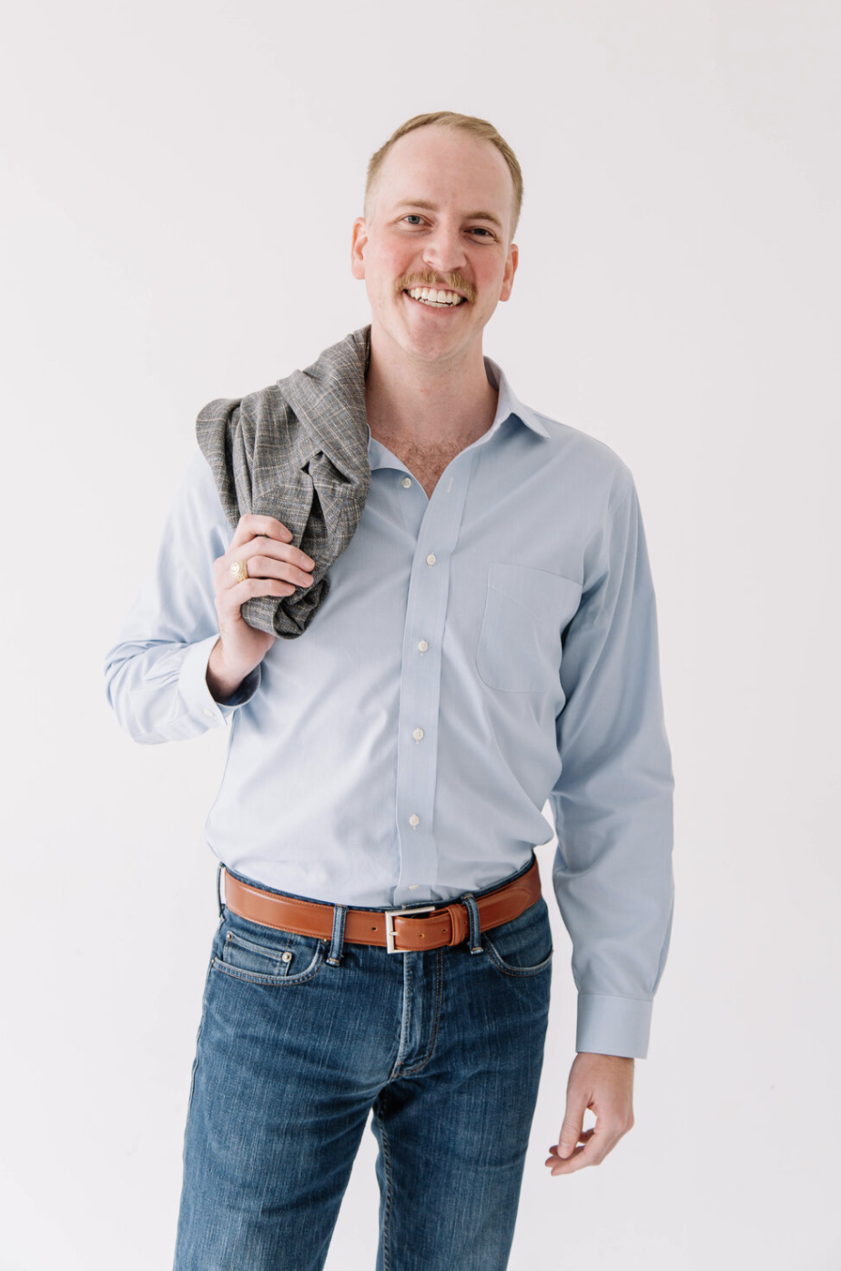Chief Operating Officer Chris Mellina 0f 6th Ave Storytelling - Standing pose with blazer on shoulder